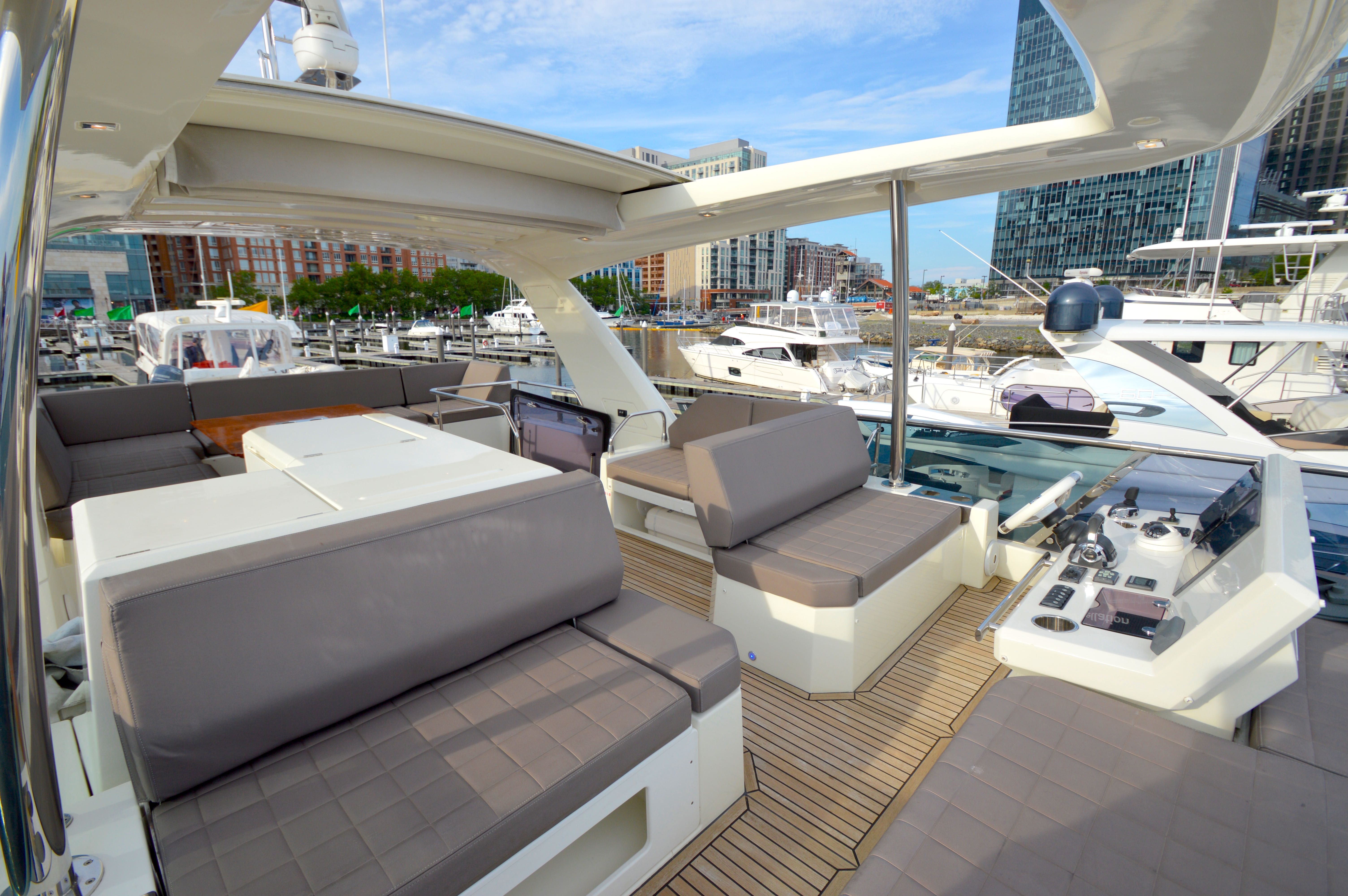Luxury yacht Prestige 630 from 2017 in modern marina.