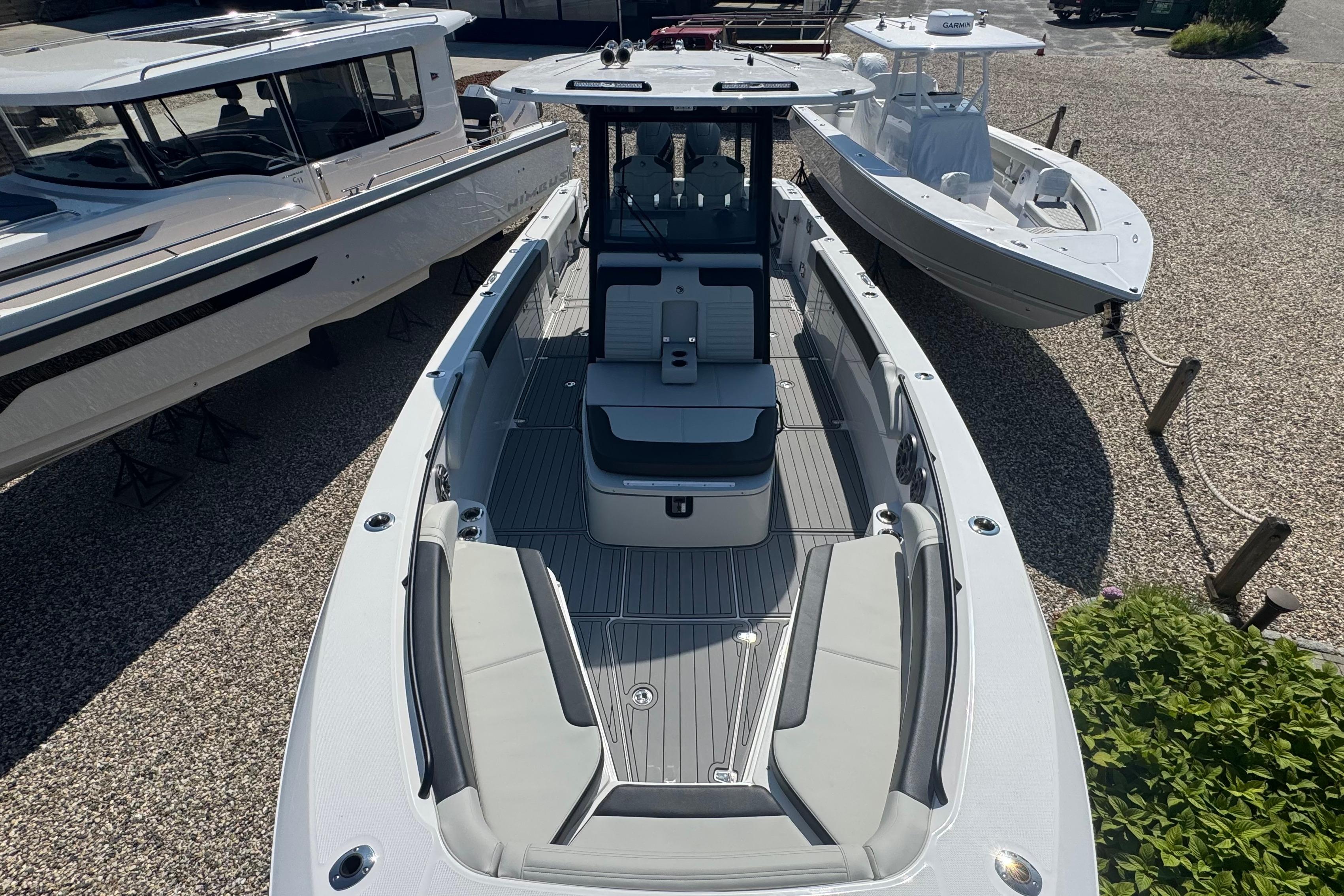 2025 Edgewater 340CC boat with sleek design and spacious seating, docked outdoors.