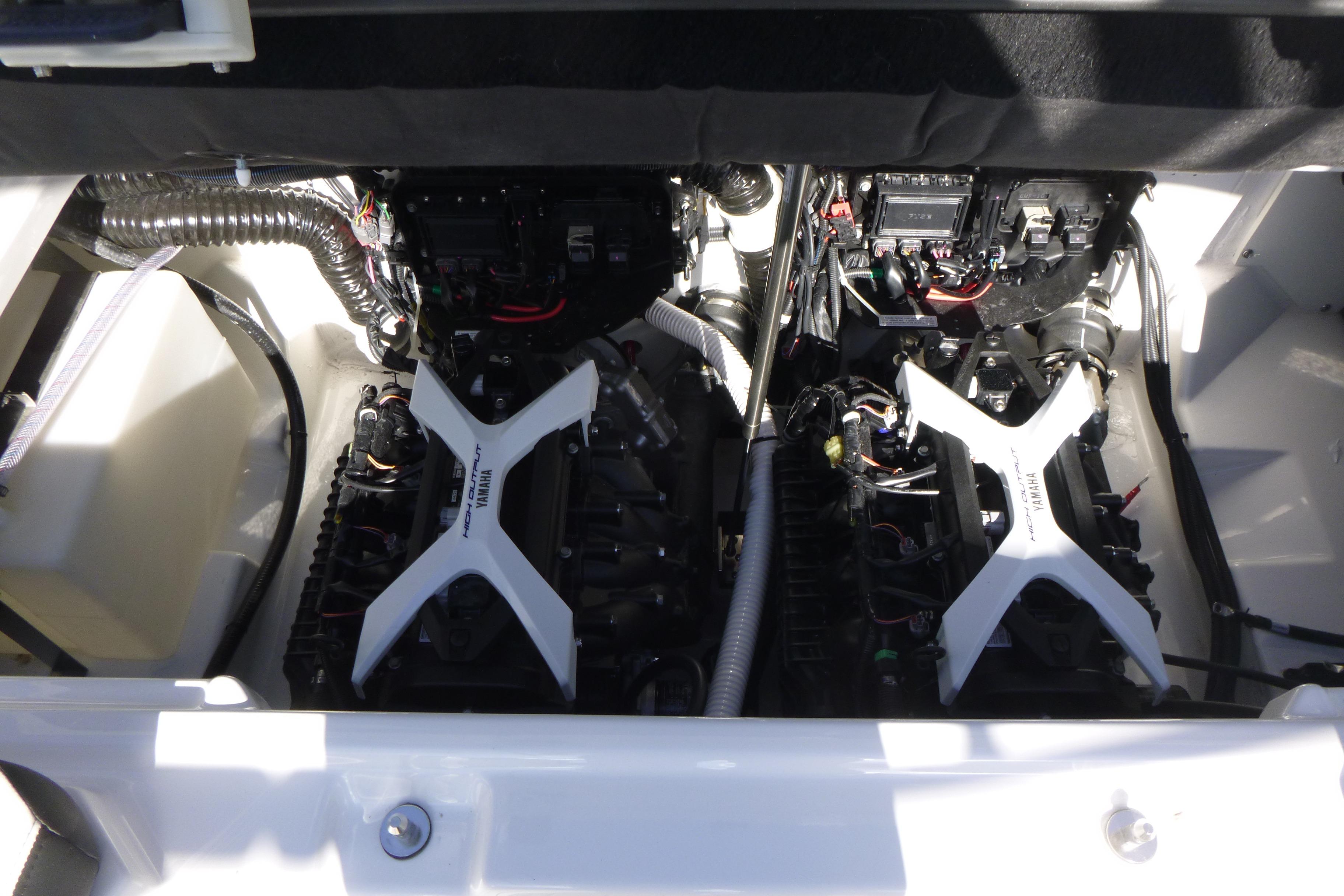 Engine compartment of 2026 Yamaha Boats 252SD, showcasing dual engines and mechanical components.
