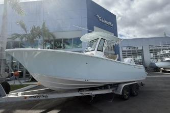 2026 Sportsman Open 232 Center Console boat on trailer outside dealership.