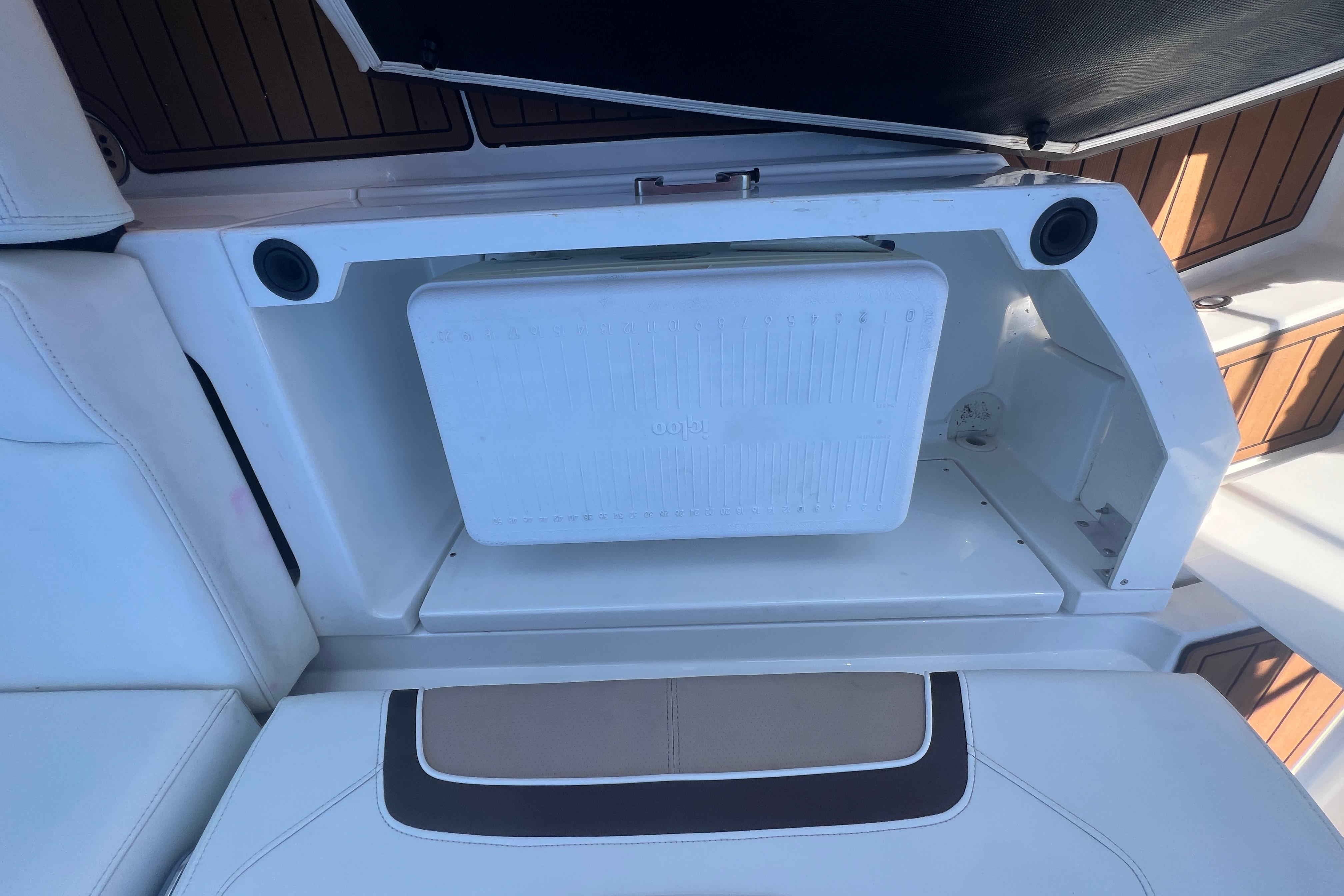 Storage compartment on a 2017 Monterey 298SS Super Sport boat with integrated cooler.