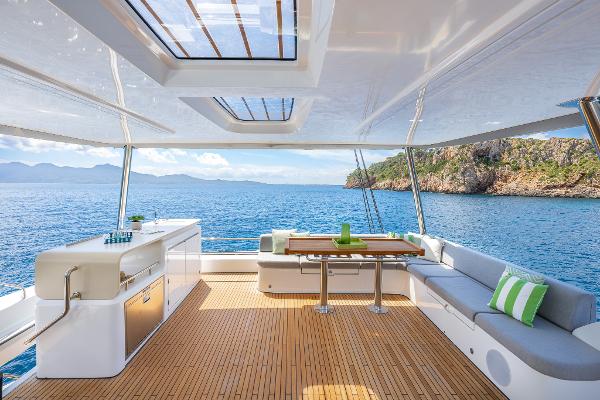 Luxurious Lagoon 60 yacht interior, 2025 model, featuring spacious deck and stunning ocean view.