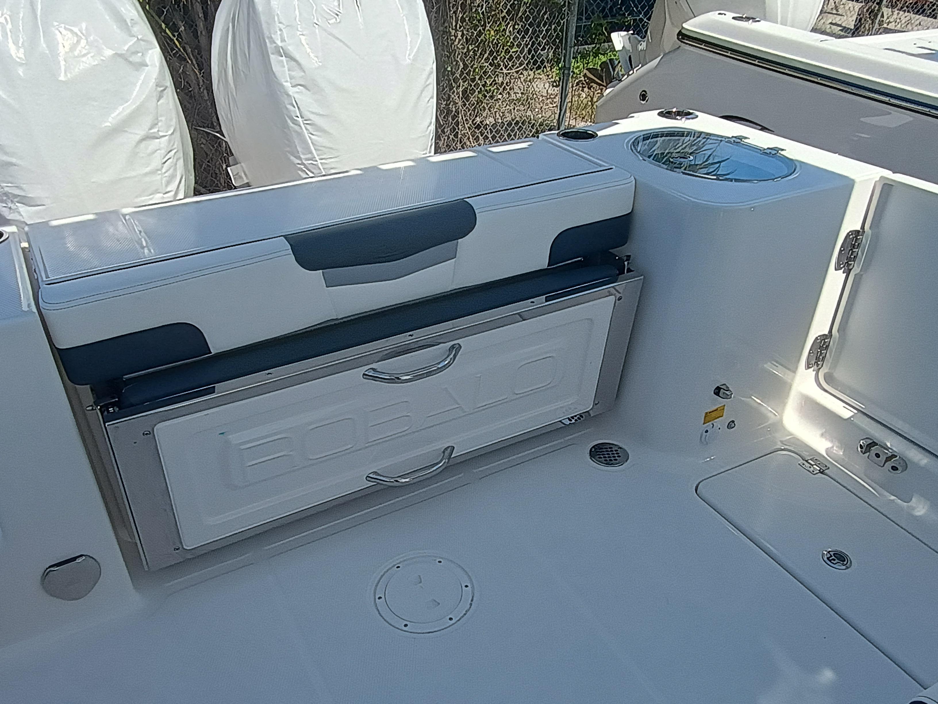 2025 Robalo R257 Dual Console boat interior with seating and storage compartment.