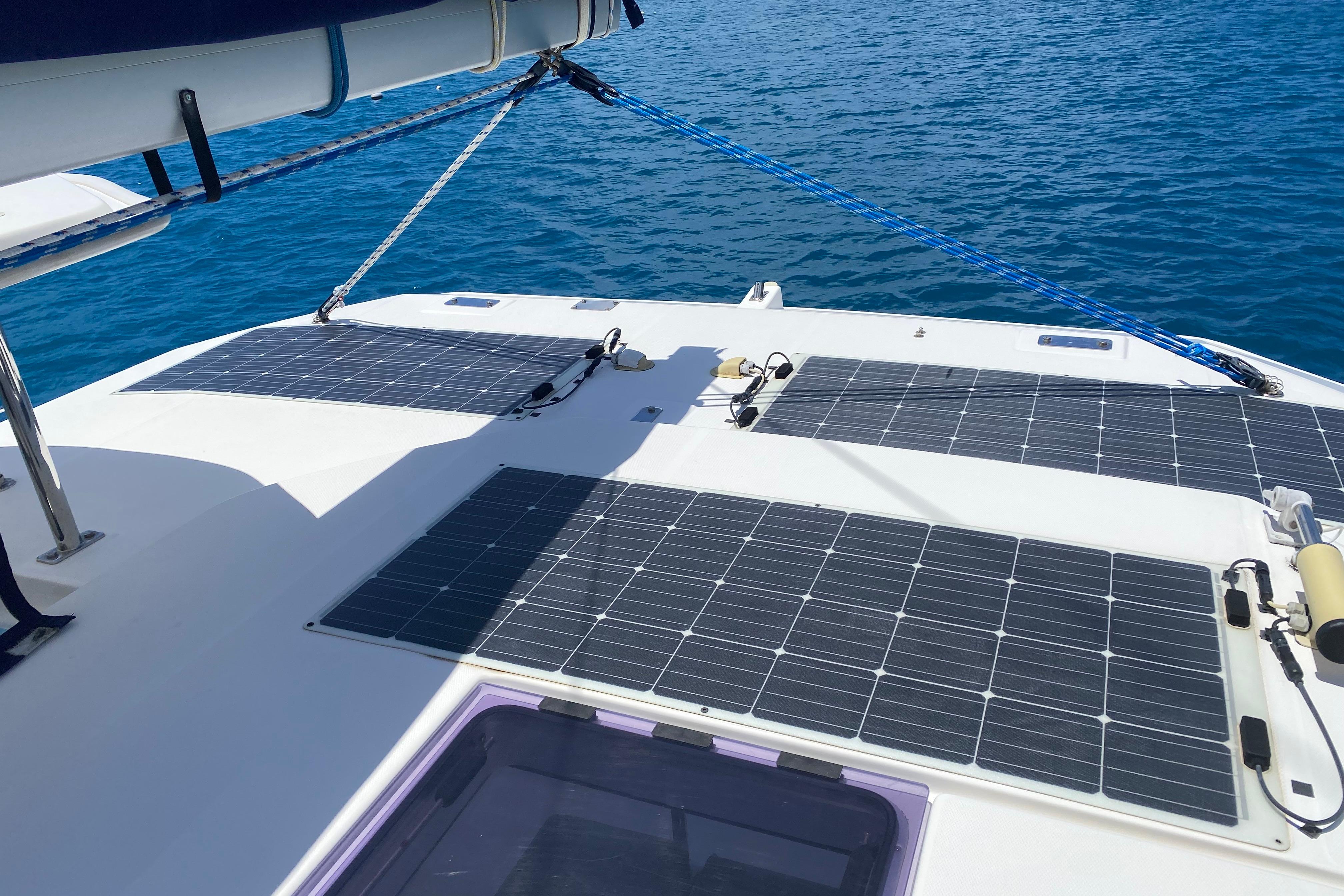 Solar panels on a 2017 Leopard 40 catamaran, sailing on clear blue water.