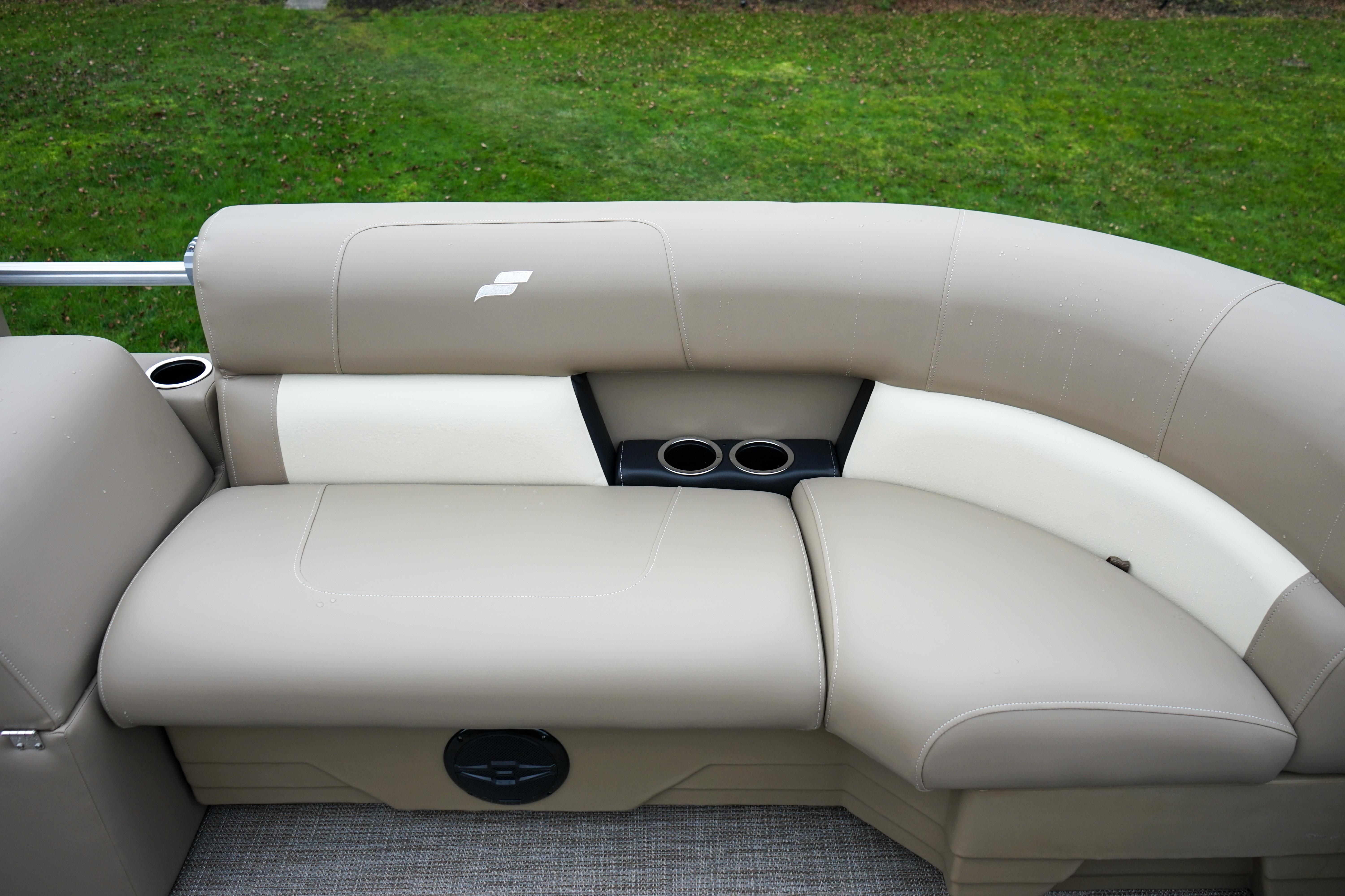 Luxurious beige seating on 2025 Starcraft LX16R boat, featuring cup holders and stylish design.