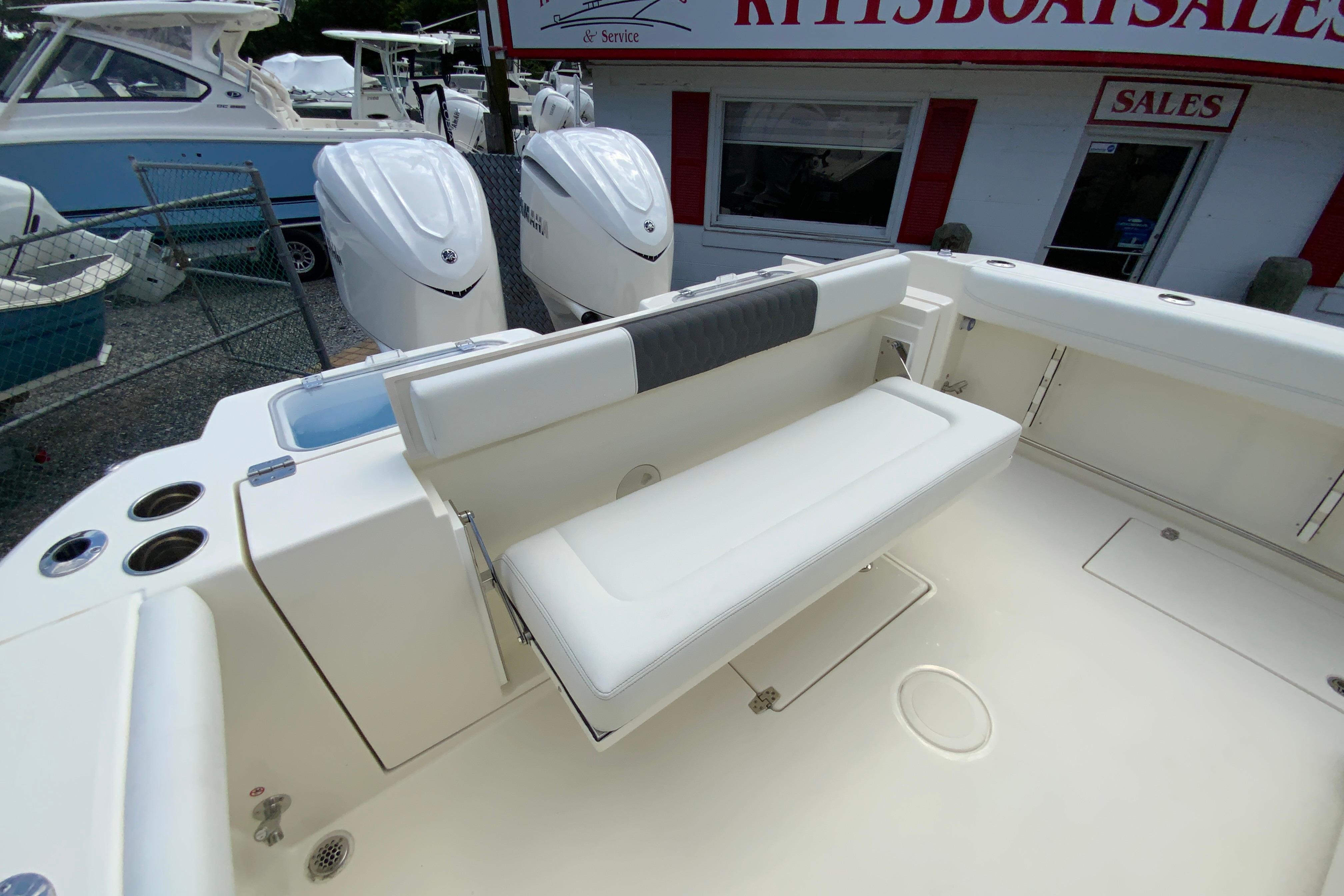 2027 Cobia 320 Center Console boat interior with seating and dual outboard engines.