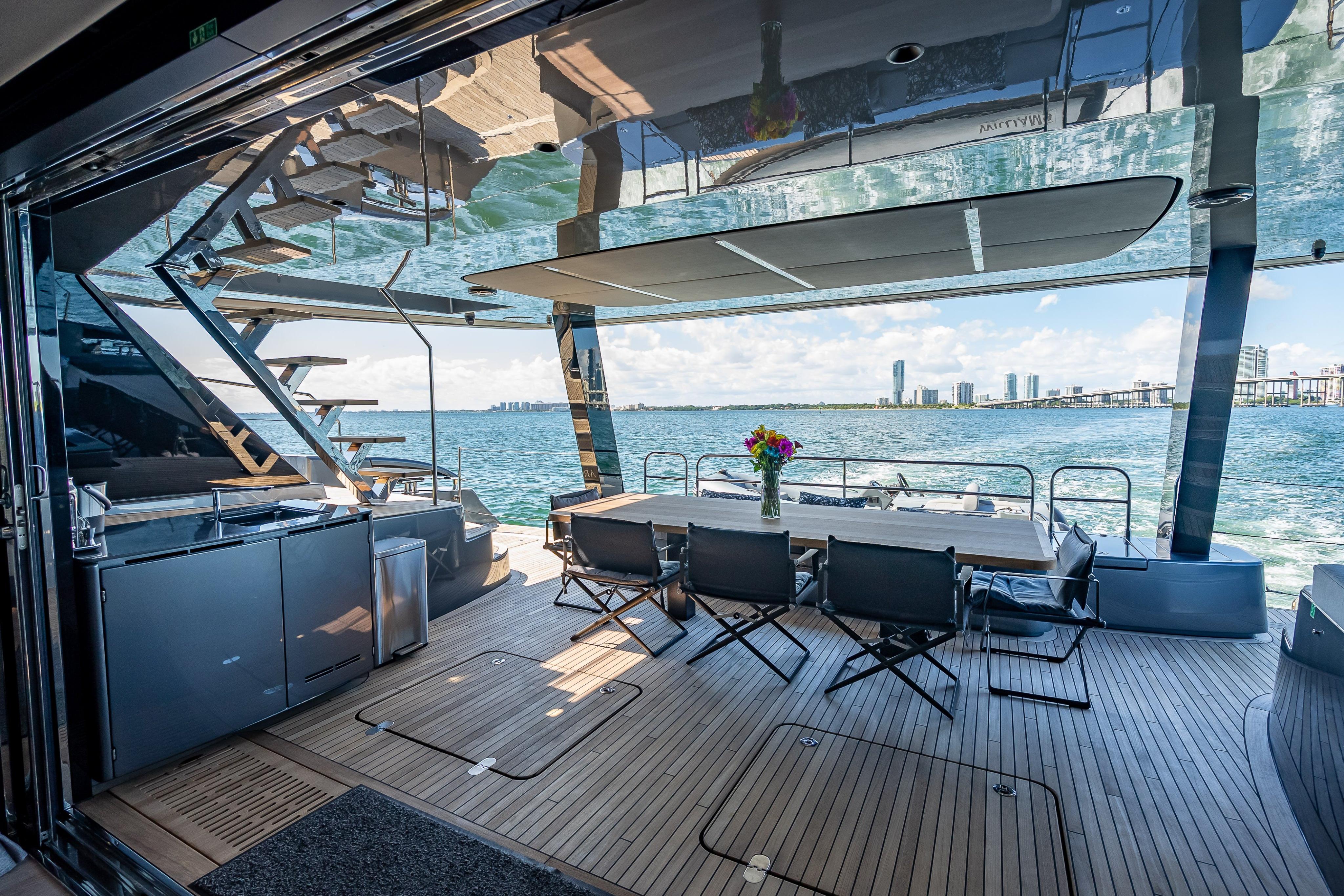 Luxurious Sunreef 60 Power yacht deck with dining area, ocean view, and modern design, 2026 model.