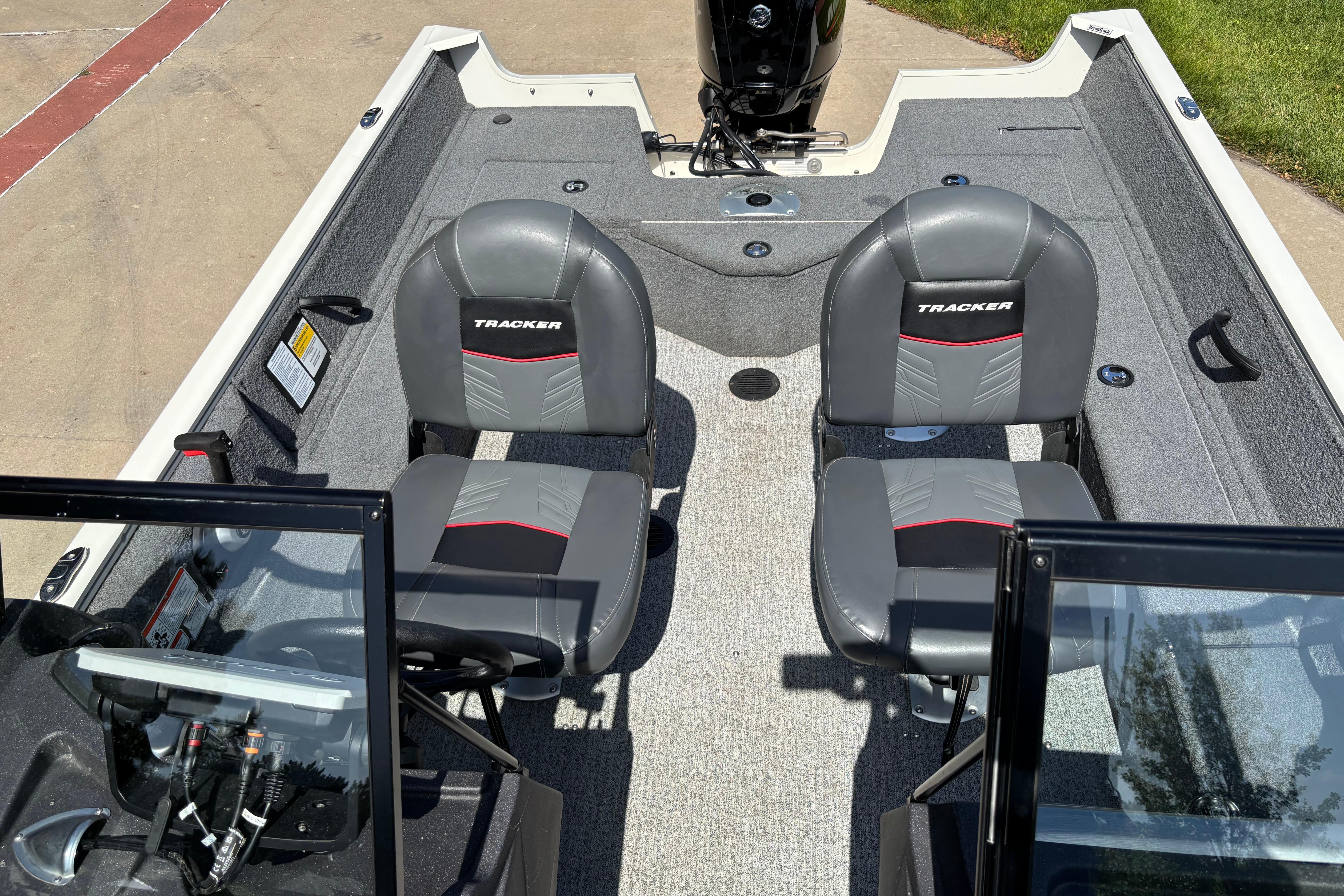 2022 Tracker Pro Guide V-16 SC boat interior with two gray seats and steering console.