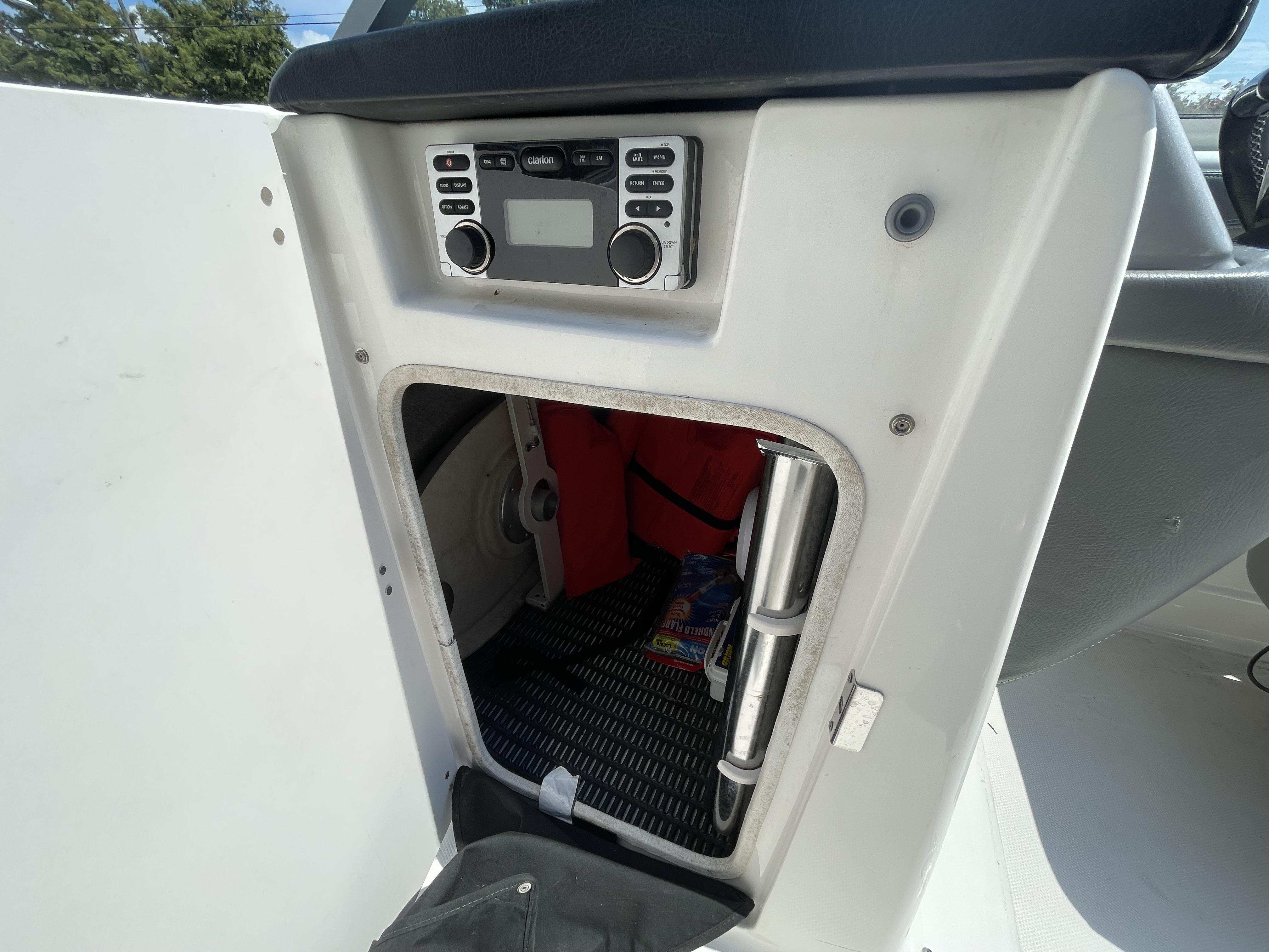 2014 Chaparral Sunesta 224 boat console with storage compartment and stereo system.