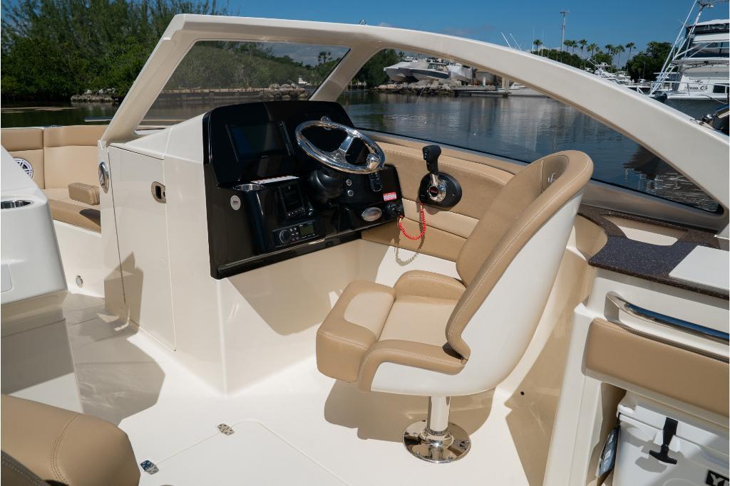 2023 Scout 240 Dorado boat interior with steering wheel and seating.