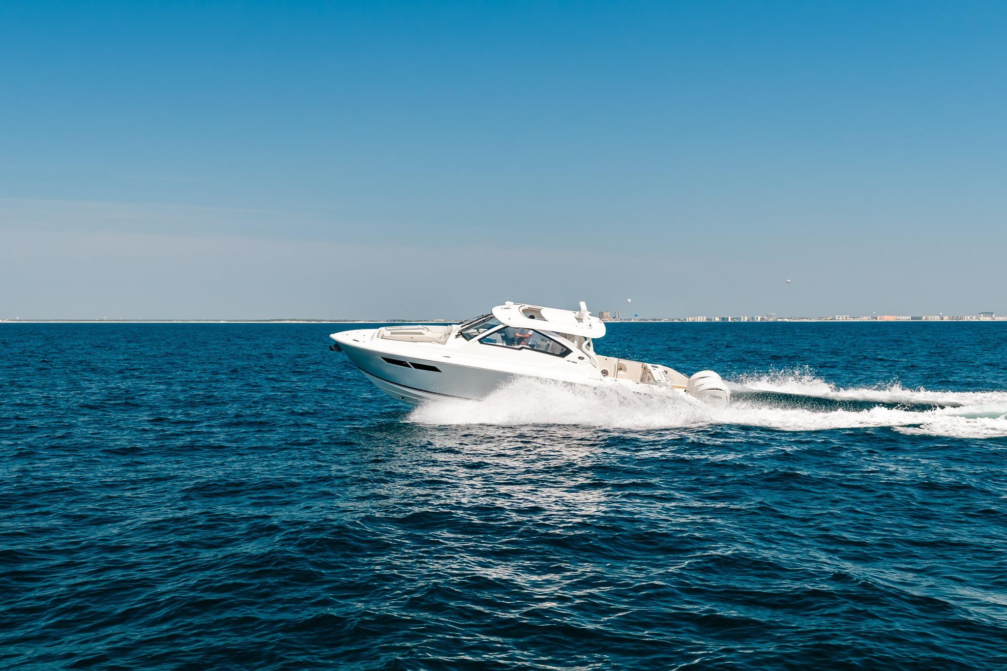 2022 Pursuit DC 365 Dual Console cruising on open blue ocean.