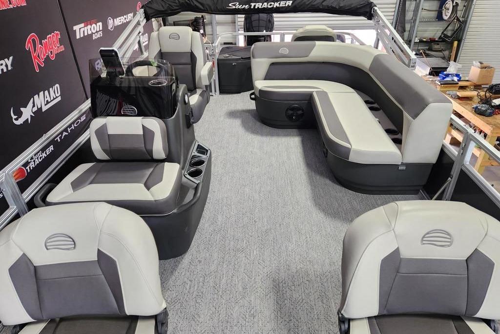2026 Sun Tracker Bass Buggy 18 DLX pontoon boat interior with gray seating and helm.
