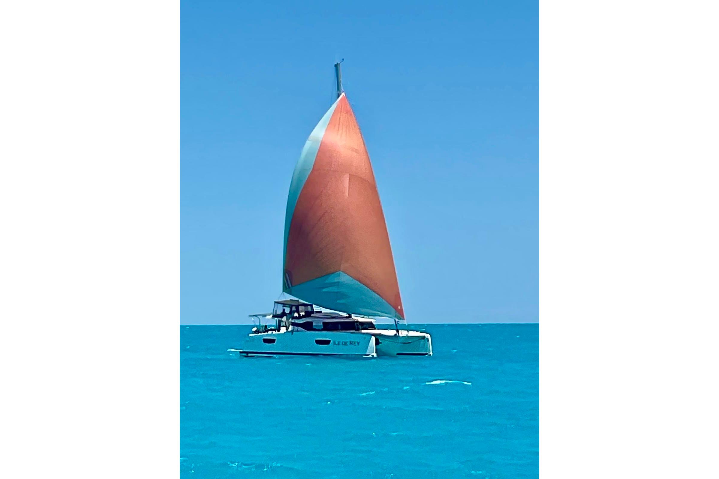 2020 Fountaine Pajot Saona 47 sailing on clear blue waters with vibrant sails.