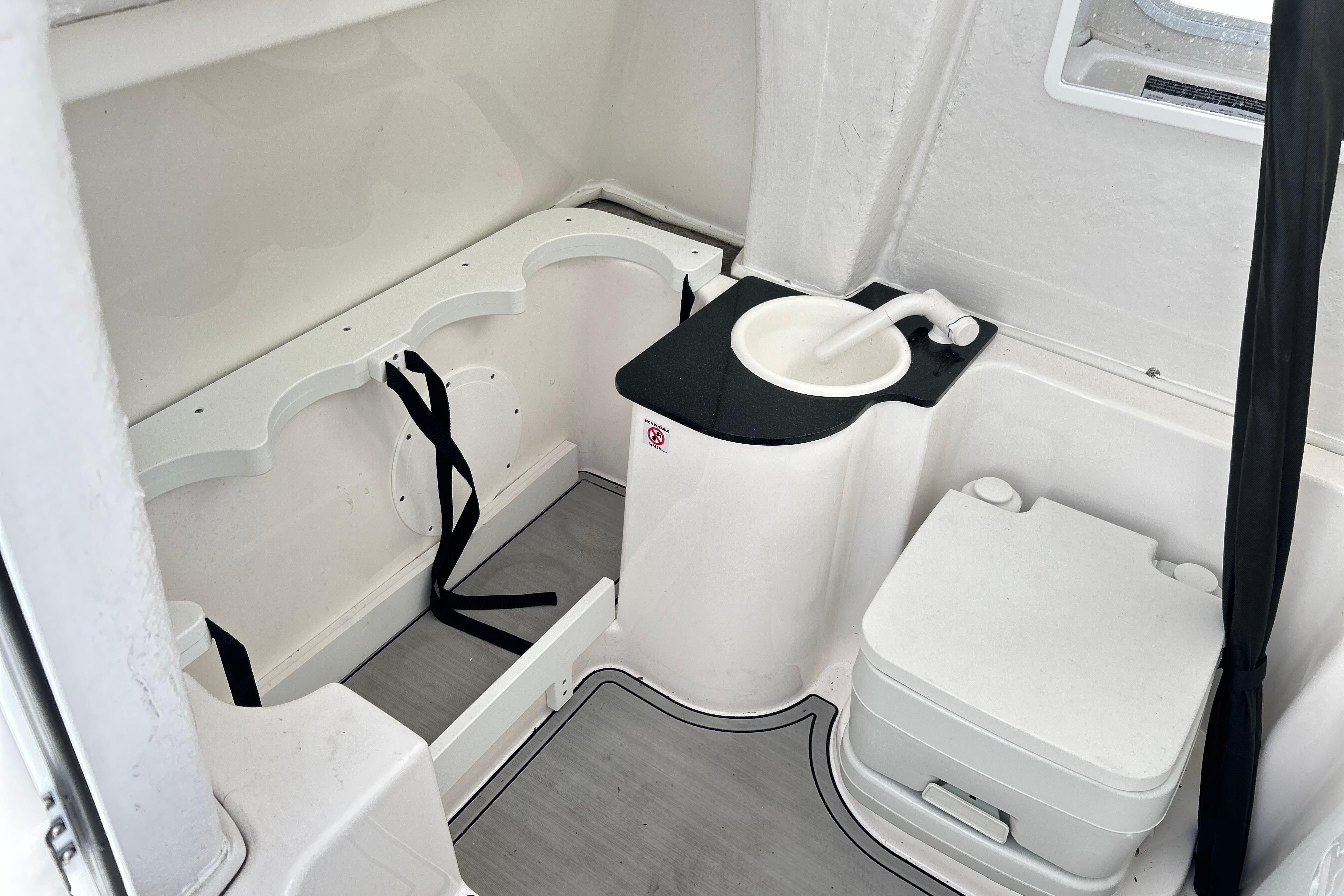 2024 Sea Fox 268 Commander boat interior with compact sink and toilet.