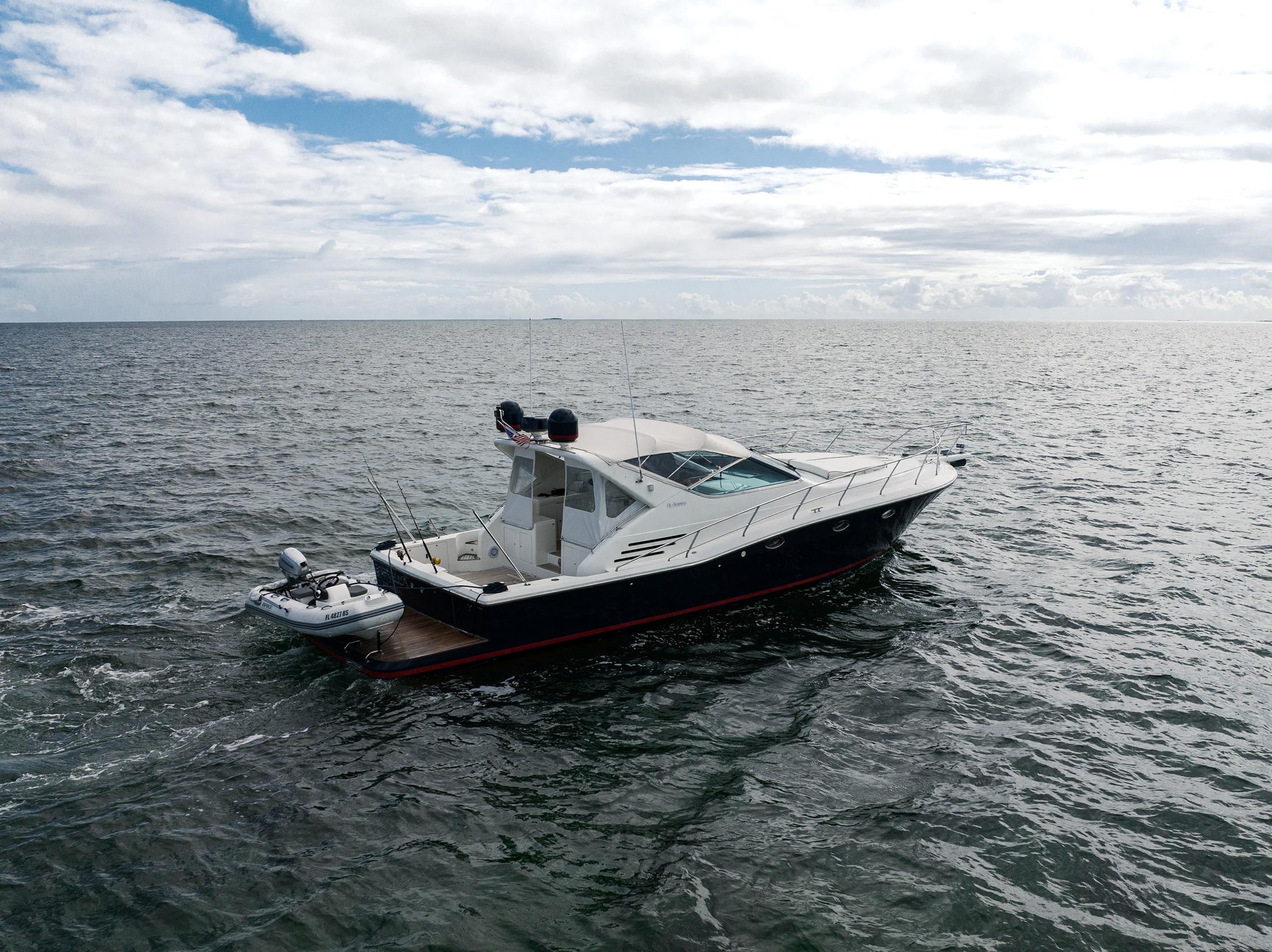 2001 Uniesse 48 Open yacht cruising on open water under cloudy skies.