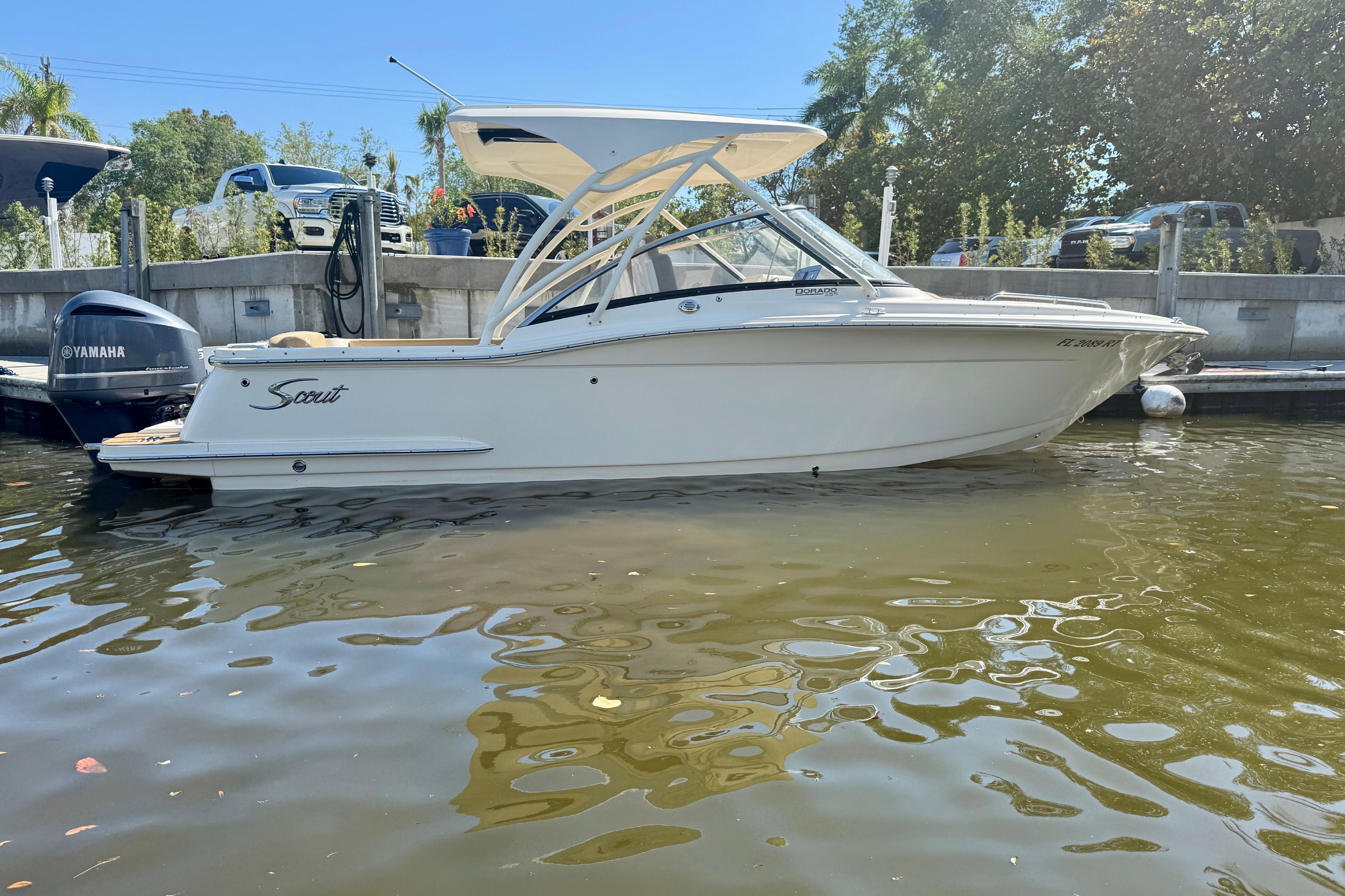 2019 Scout 255 Dorado boat docked, featuring sleek design and Yamaha outboard motor.