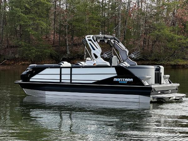 2025 Montara Surf Boss 2.0 25 pontoon boat on a calm lake.