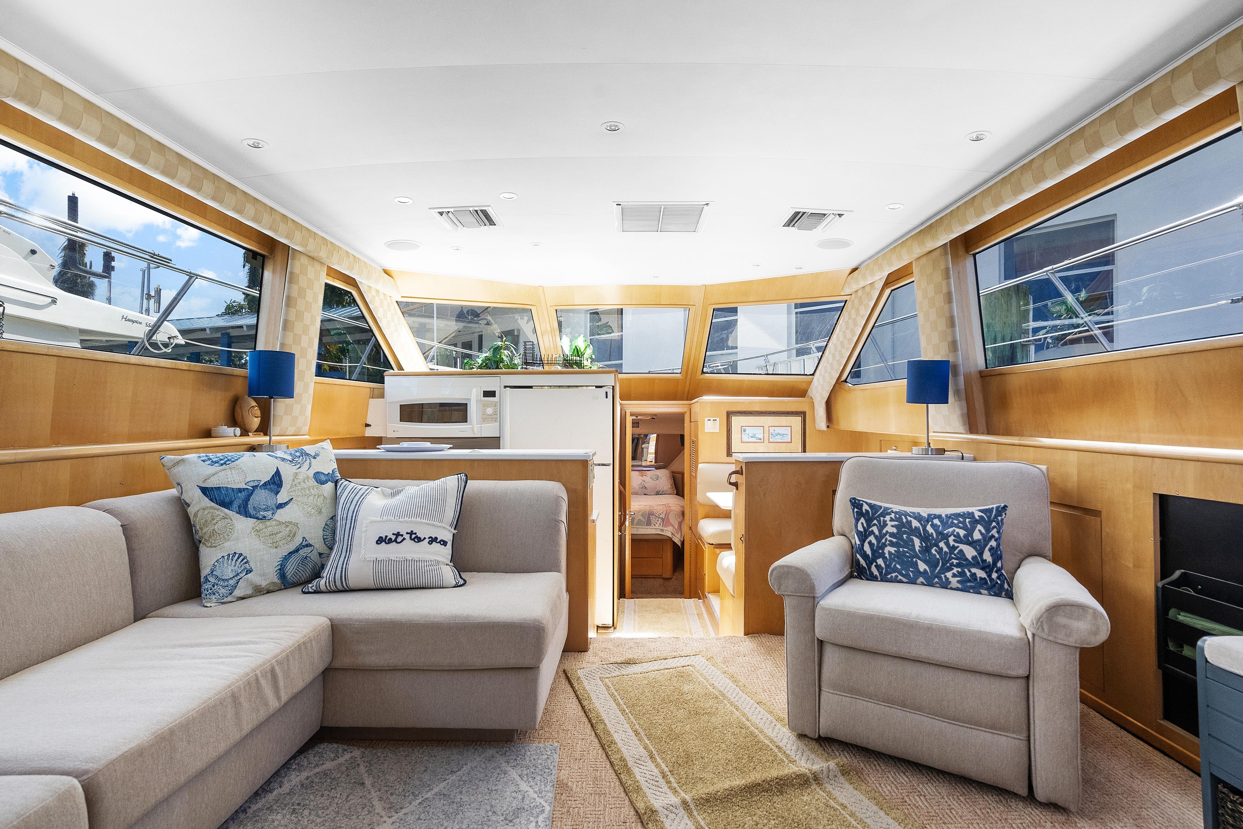 Interior of 1999 Hatteras 52 Cockpit Motor Yacht with cozy seating and modern decor.
