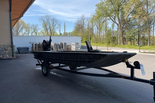 2026 Tracker Grizzly 1654 T Sportsman boat on trailer, parked outdoors.
