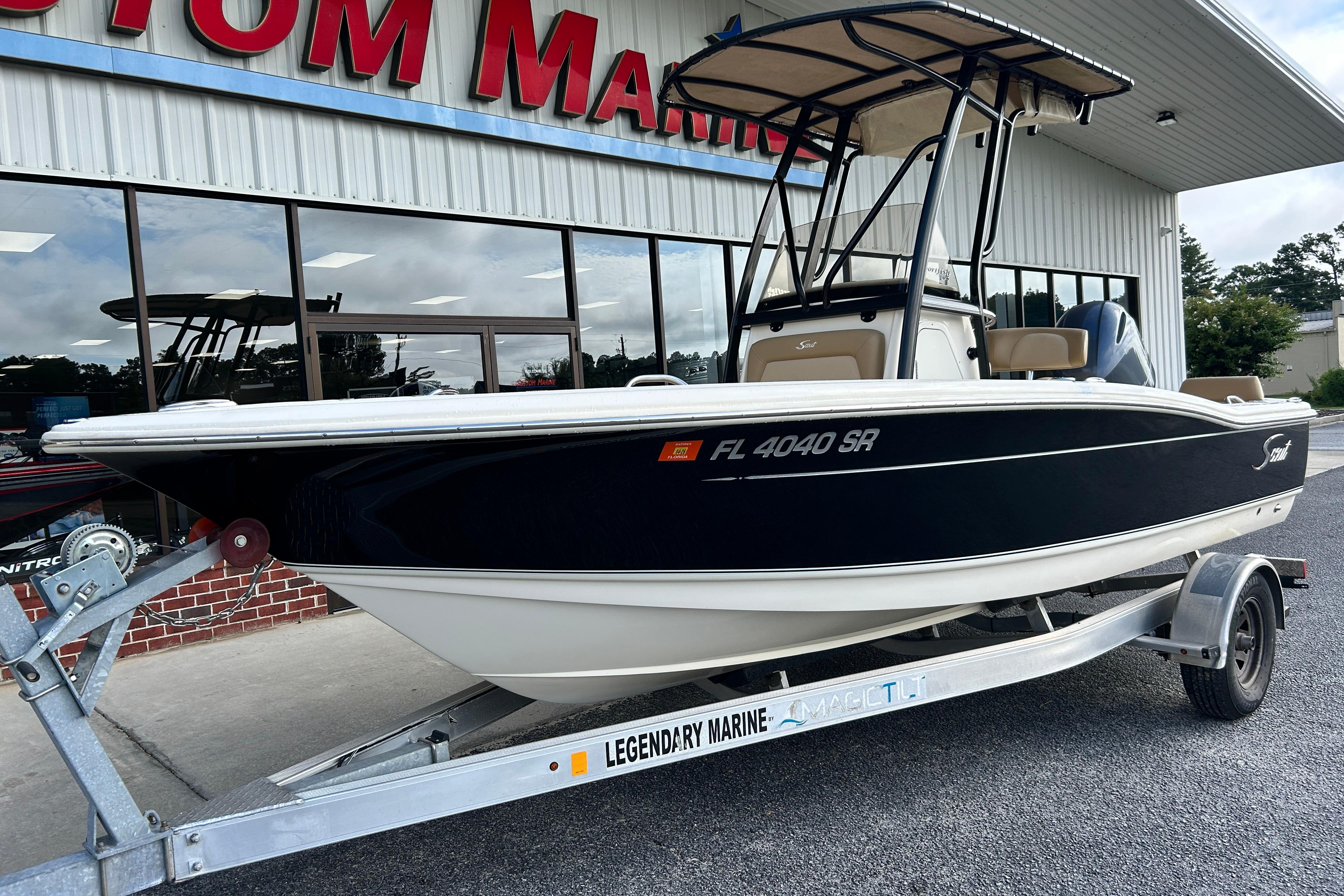 2020 Scout 195 Sportfish boat on trailer outside marine dealership.