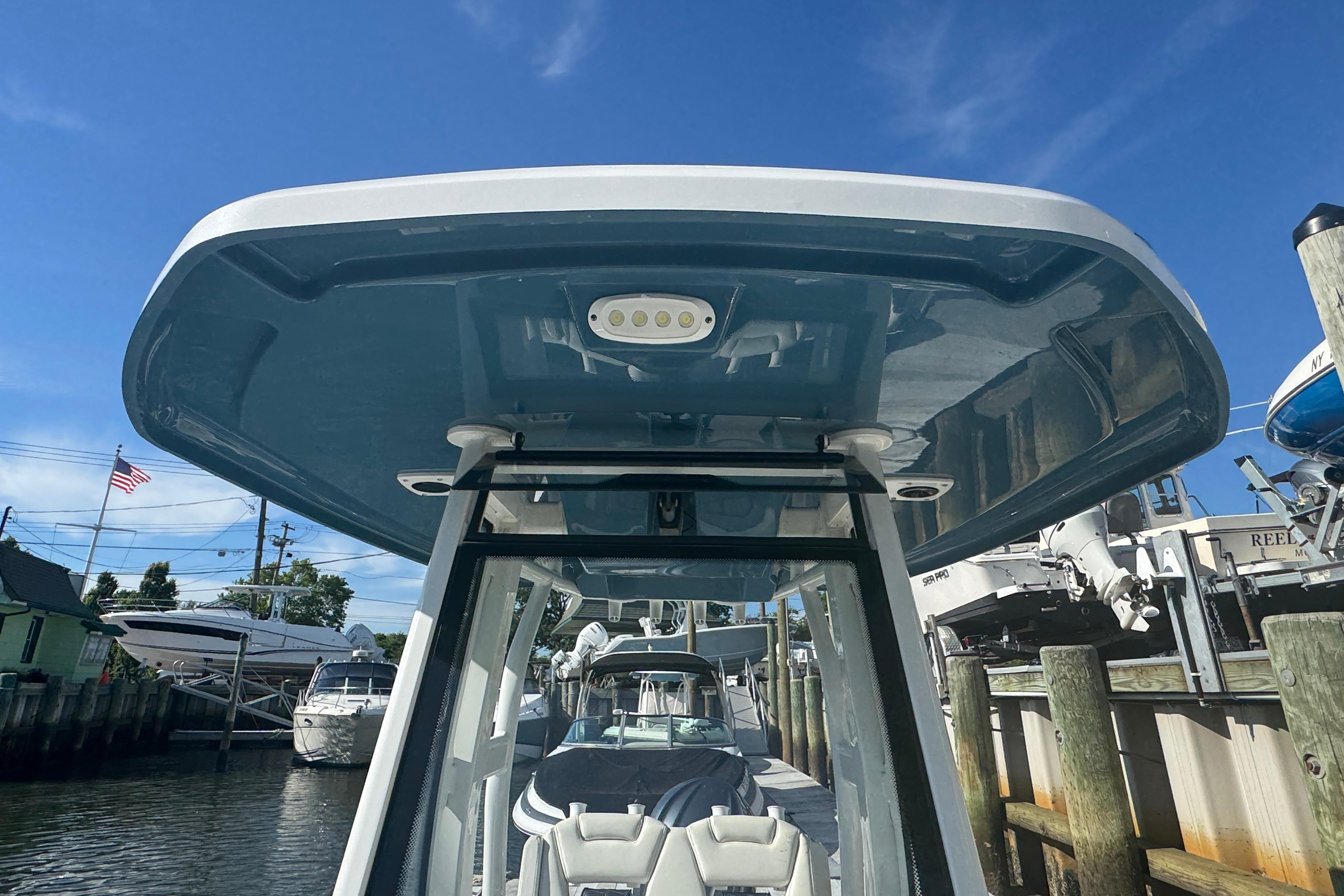 2025 Tidewater 232 LXF boat with sleek design and modern features at a marina.