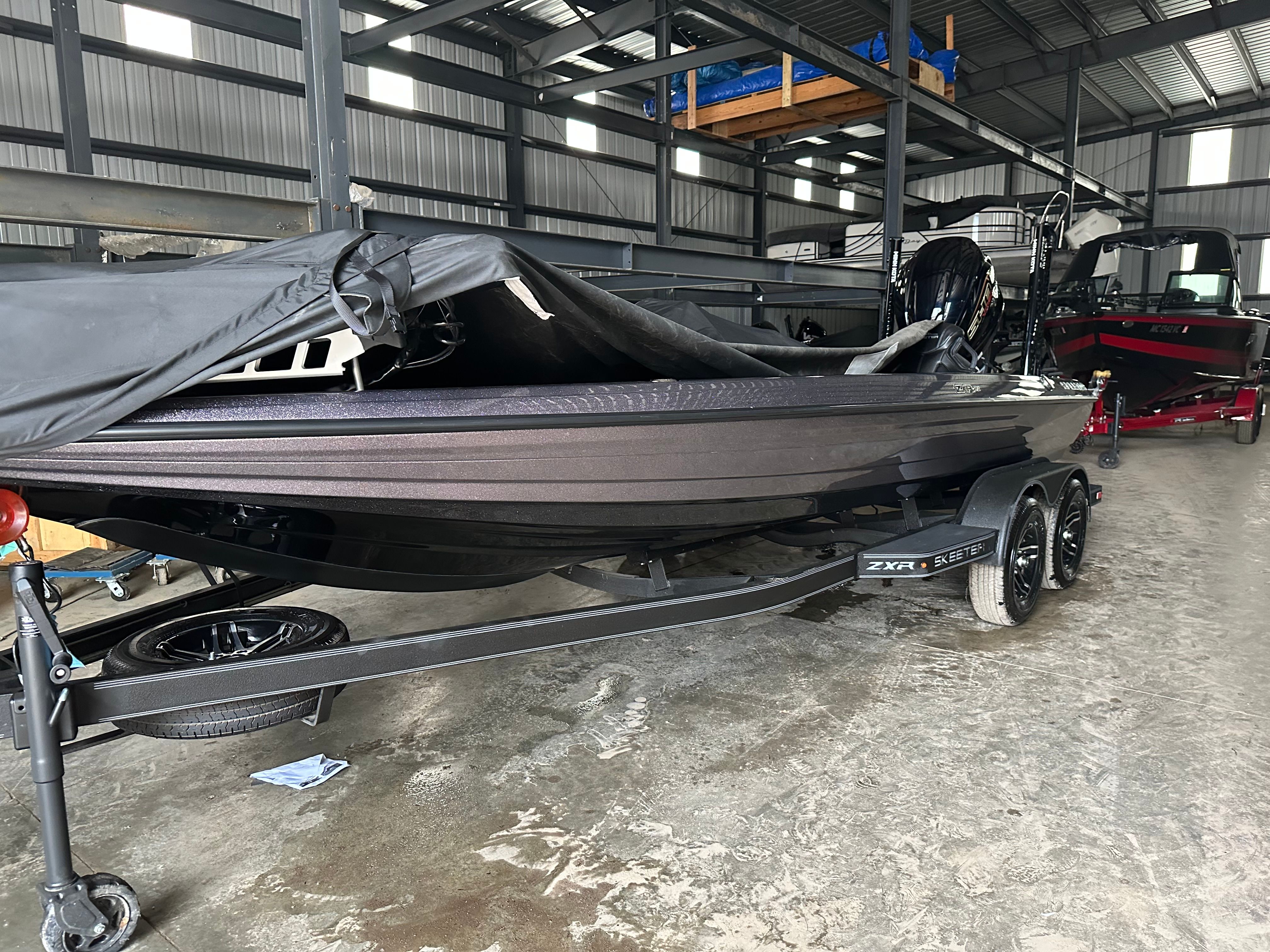 2024 Skeeter ZXR21 boat in warehouse, covered.