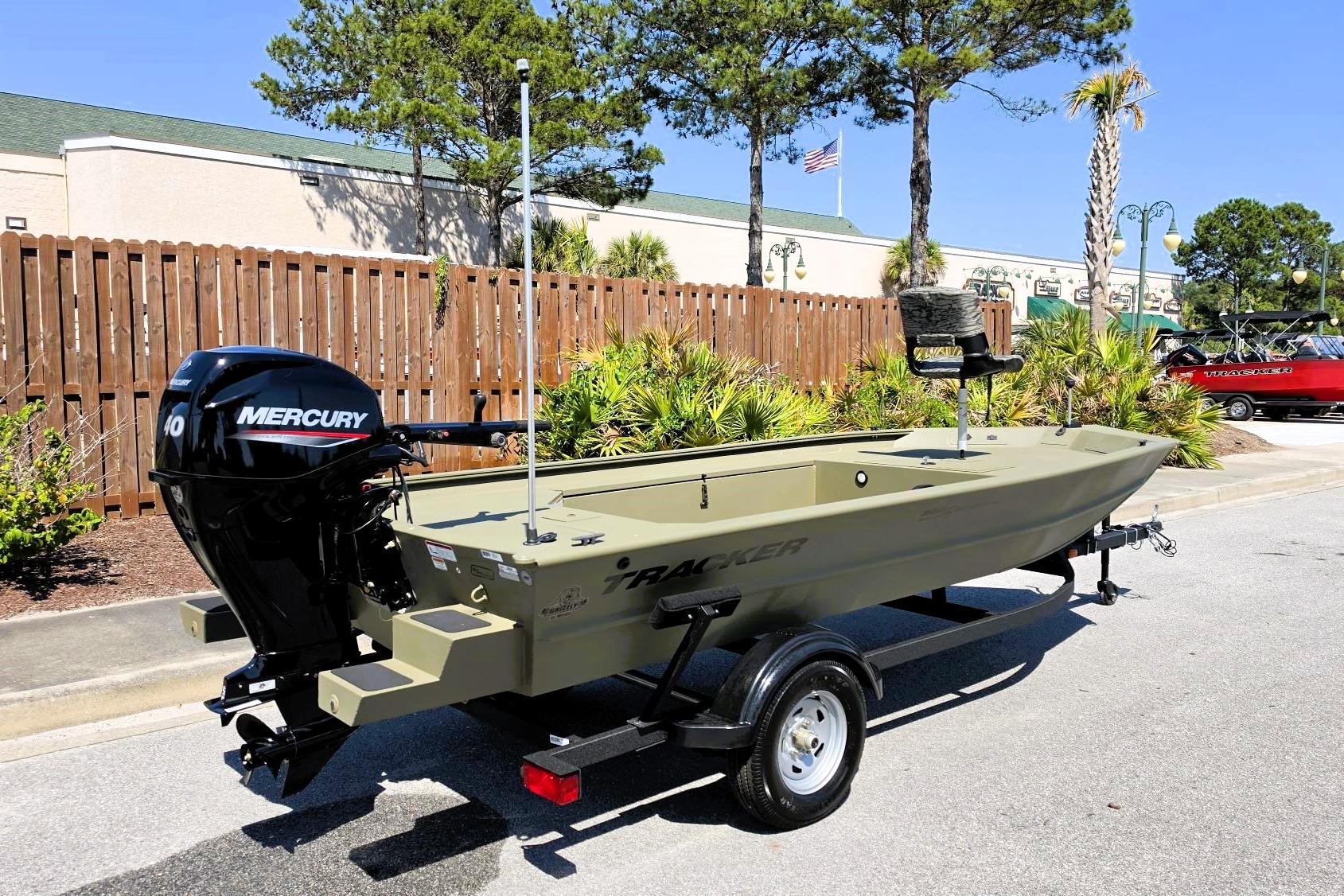 2026 Tracker Grizzly 1654 T Sportsman boat with Mercury engine on trailer.