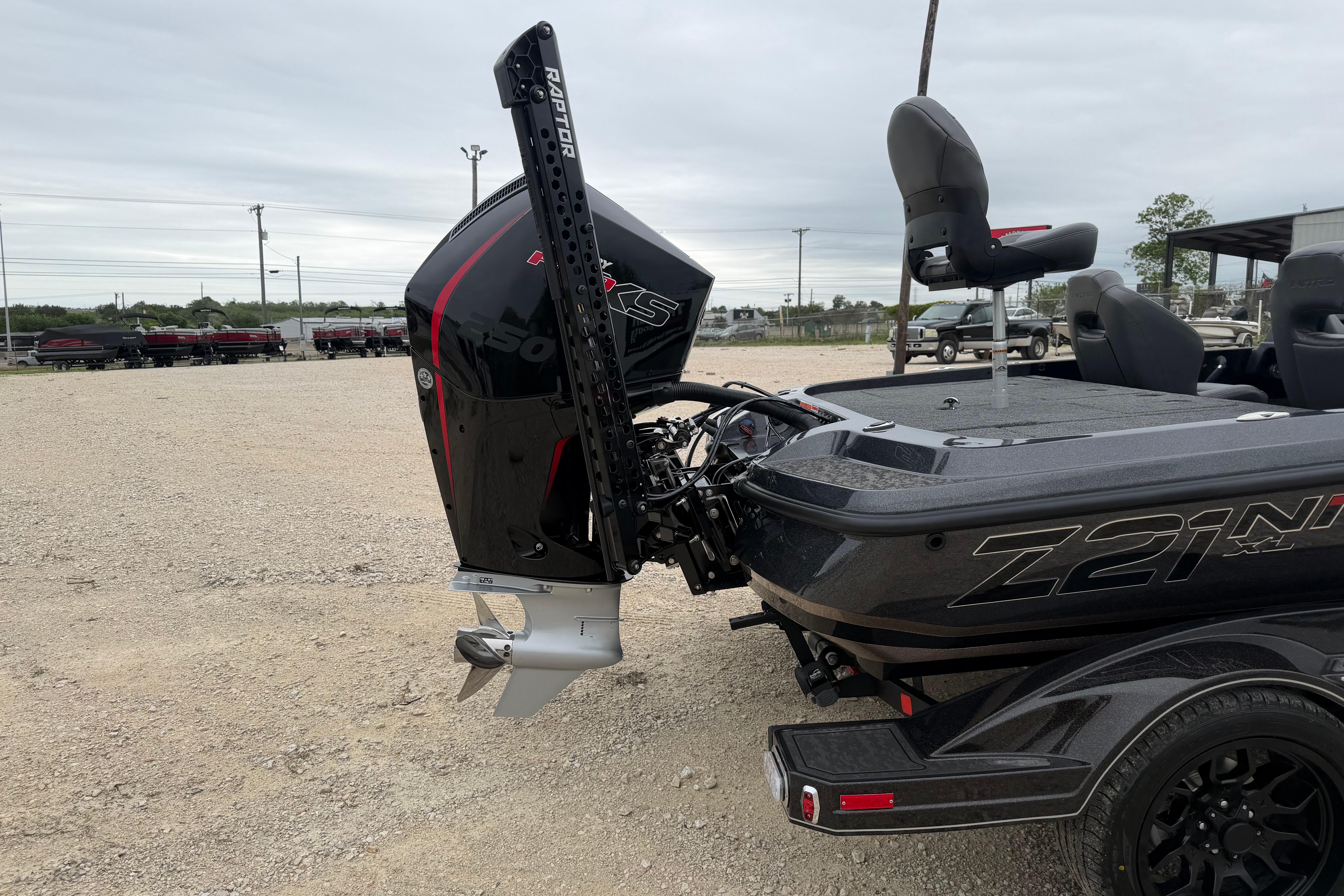 2026 Nitro Z21 XL Pro boat with powerful outboard motor in a gravel lot.