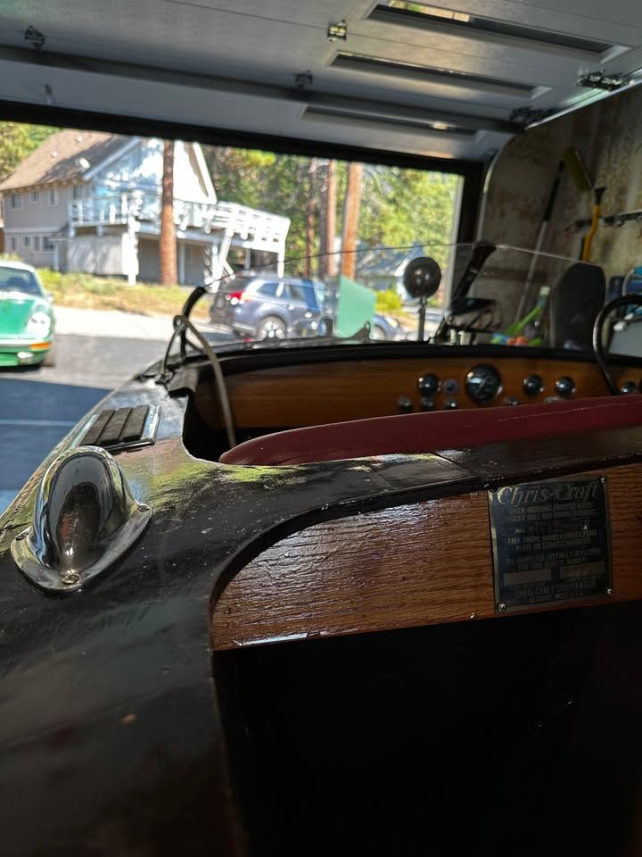 A 1957 Chris-Craft Cavalier in a garage. The dashboard and steering wheel are visible.