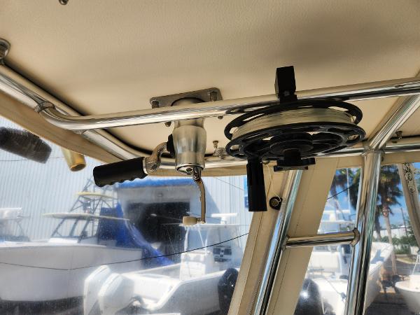 2005 Pursuit 3070 Offshore Center Console interior with fishing rod holder and reel.