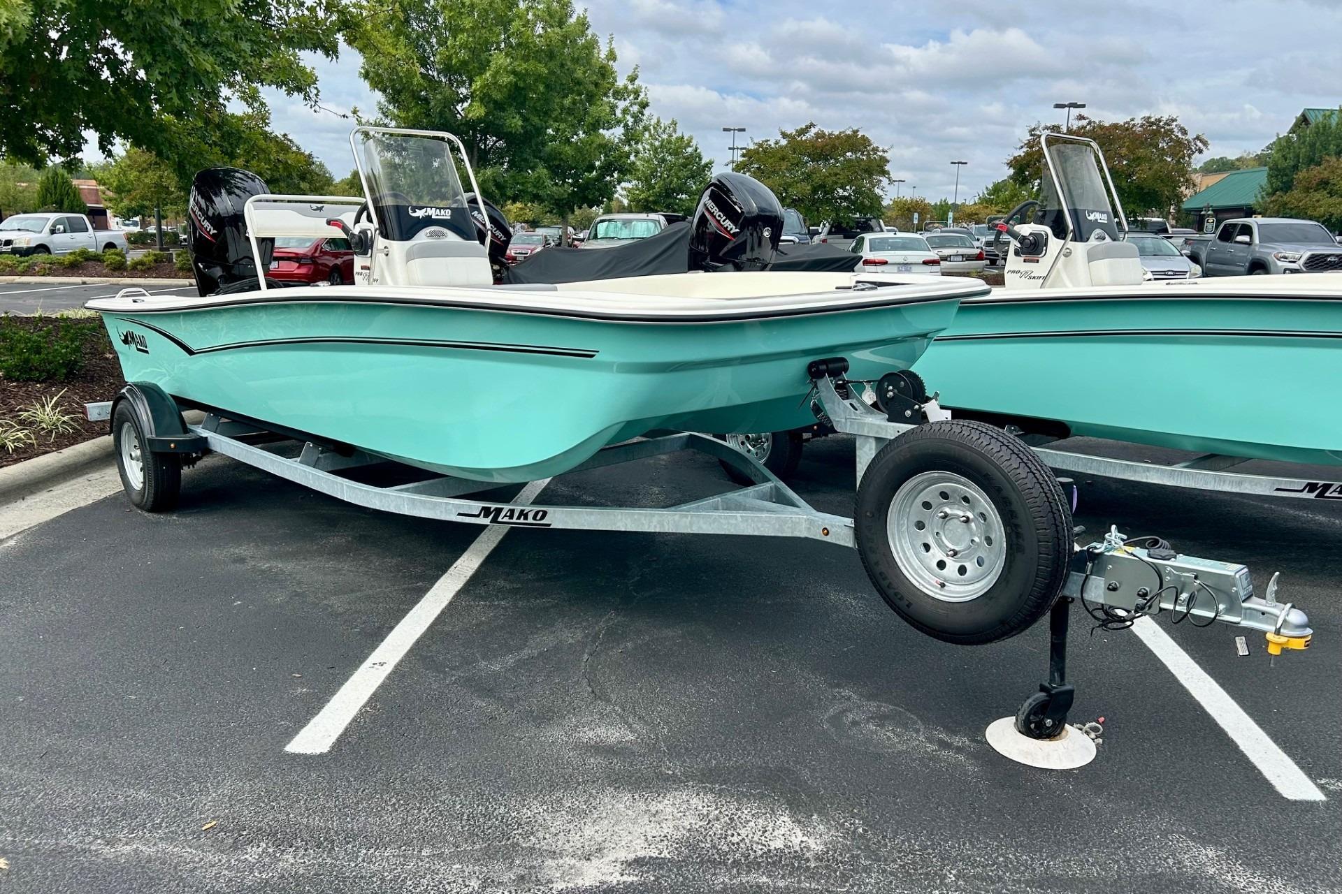 2026 Mako Pro Skiff 17 CC boat on trailer in parking lot.
