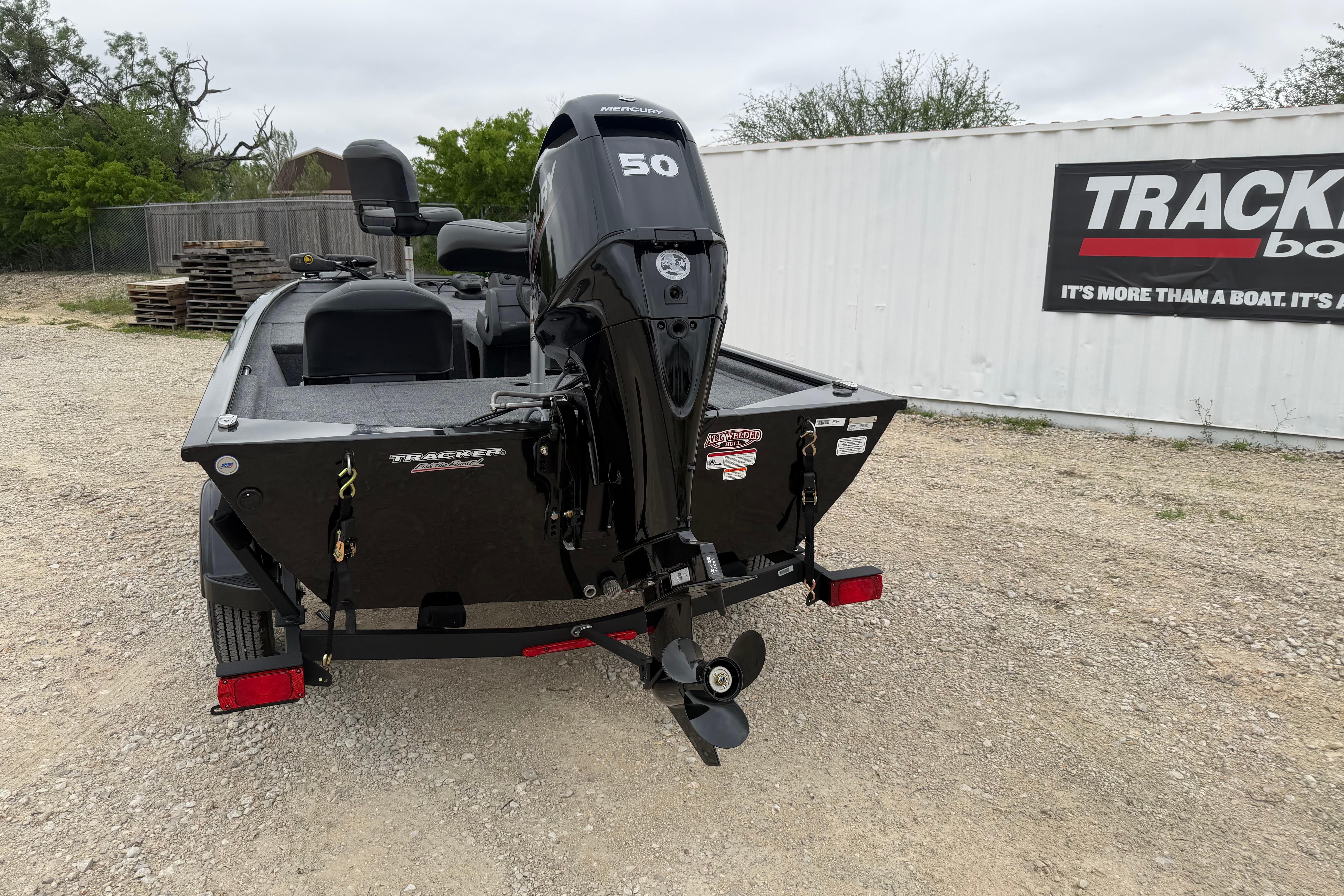 2026 Tracker Pro 170 boat with Mercury 50 engine, parked outdoors near a container.