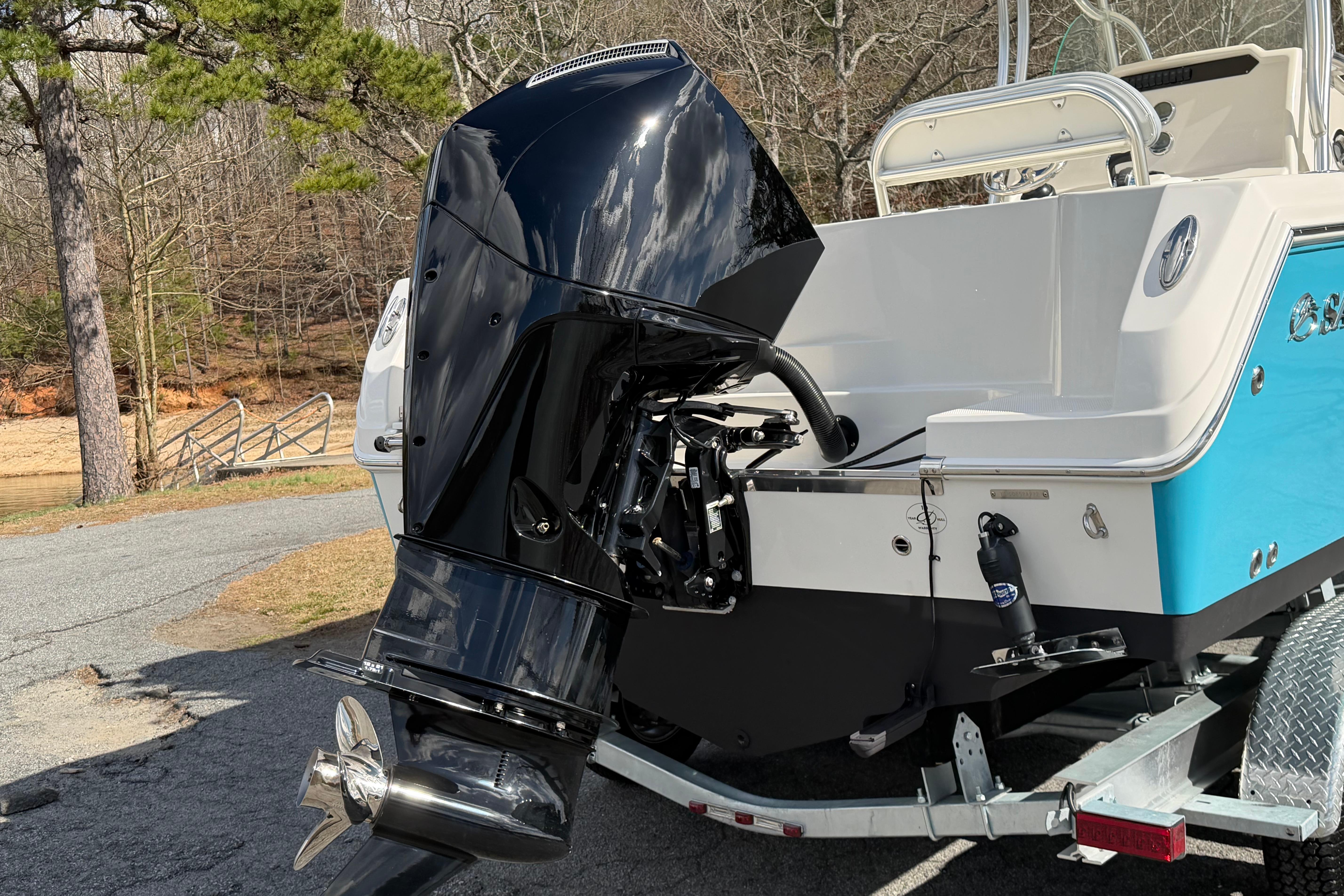 2022 Sailfish 242 CC boat with powerful outboard motor on trailer.