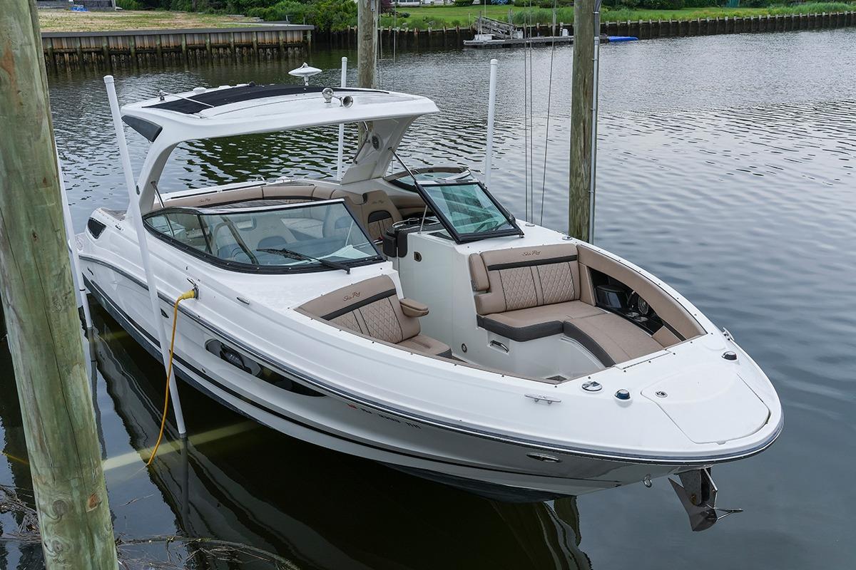 2018 Sea Ray SLX 350 boat docked on calm water, featuring sleek design and spacious seating.
