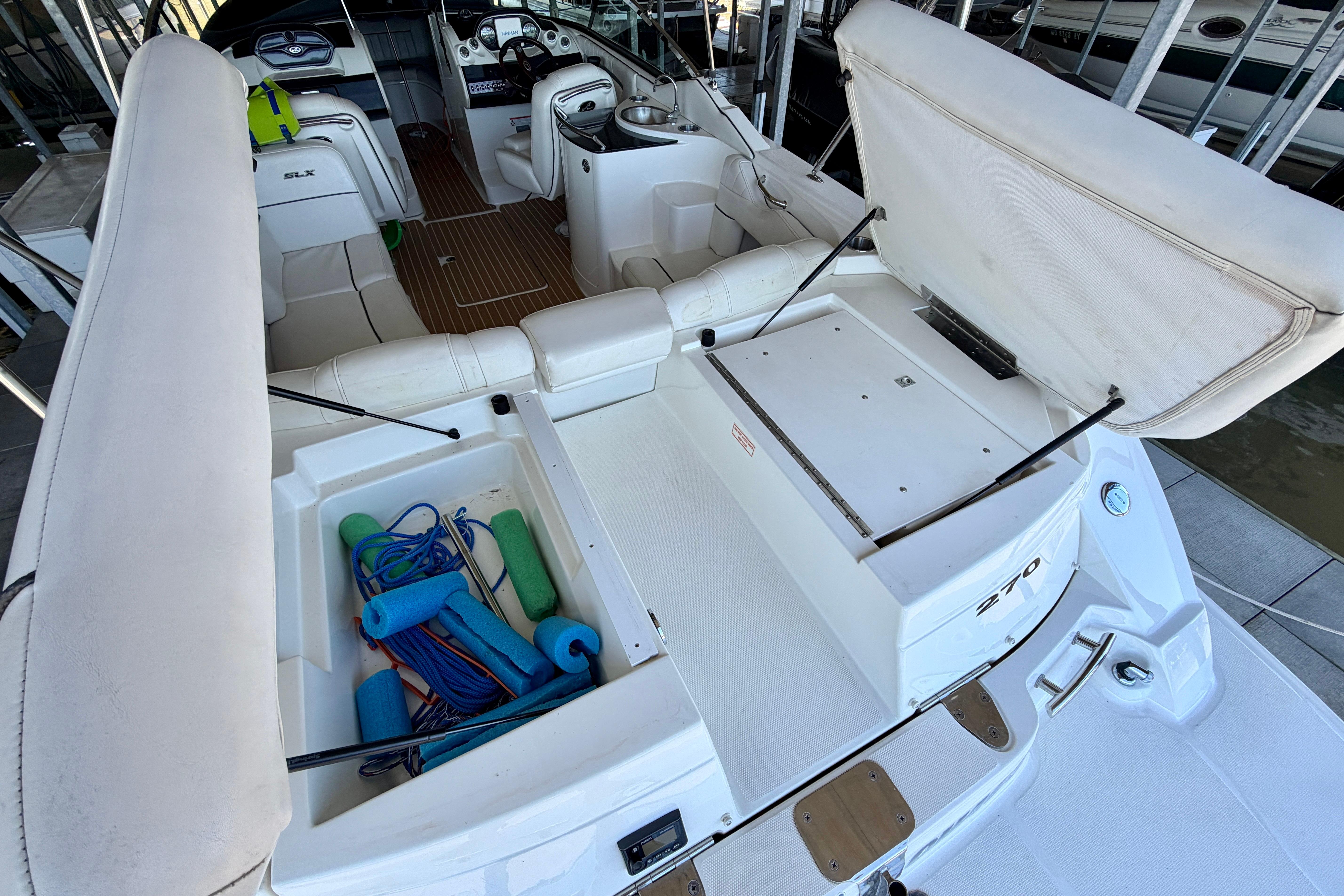 2007 Sea Ray 270 SLX boat interior with open storage compartments and seating area.
