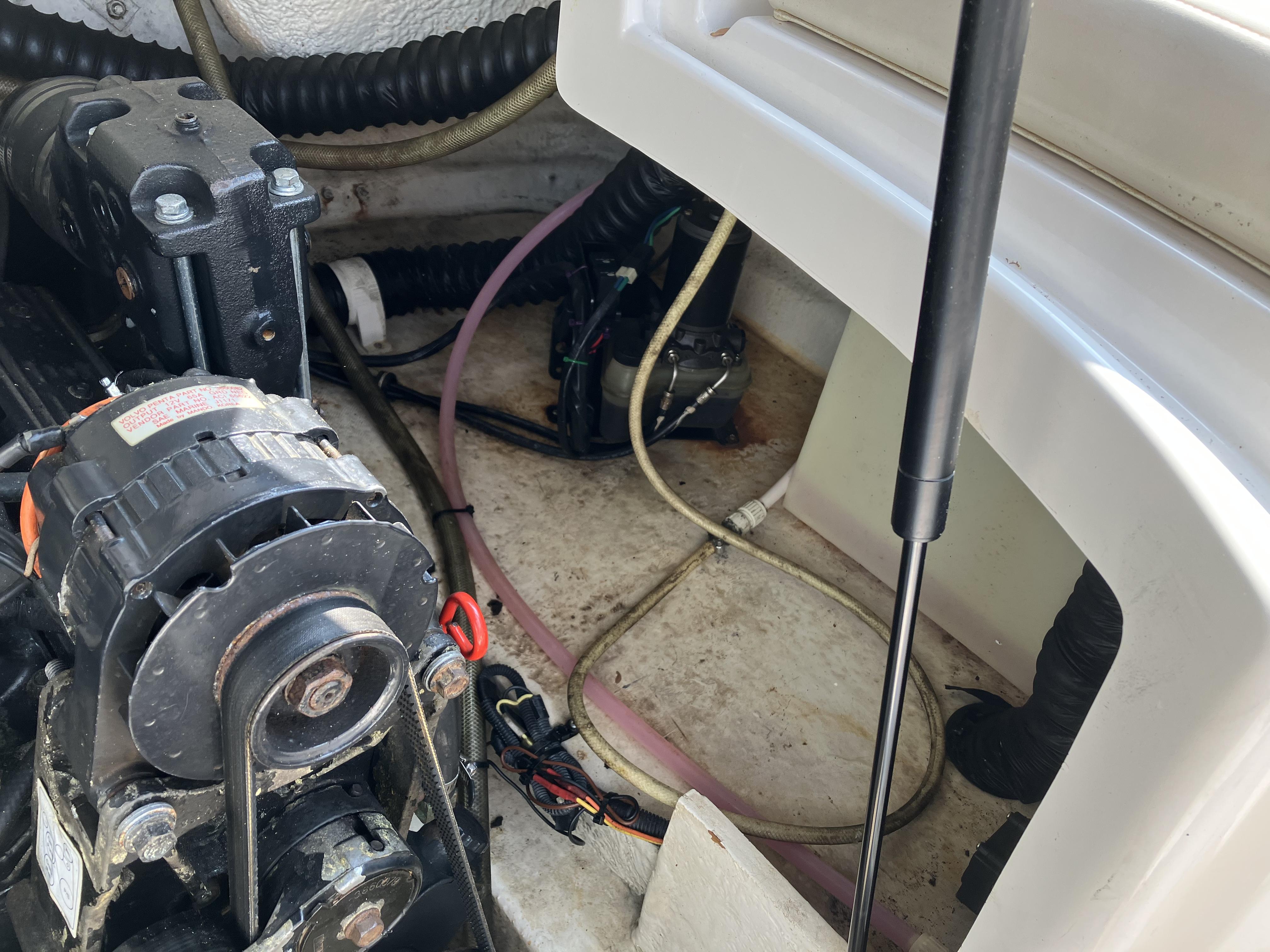 A view inside the engine compartment of a 2001 Chaparral 235 SSi, showing cables and hoses.