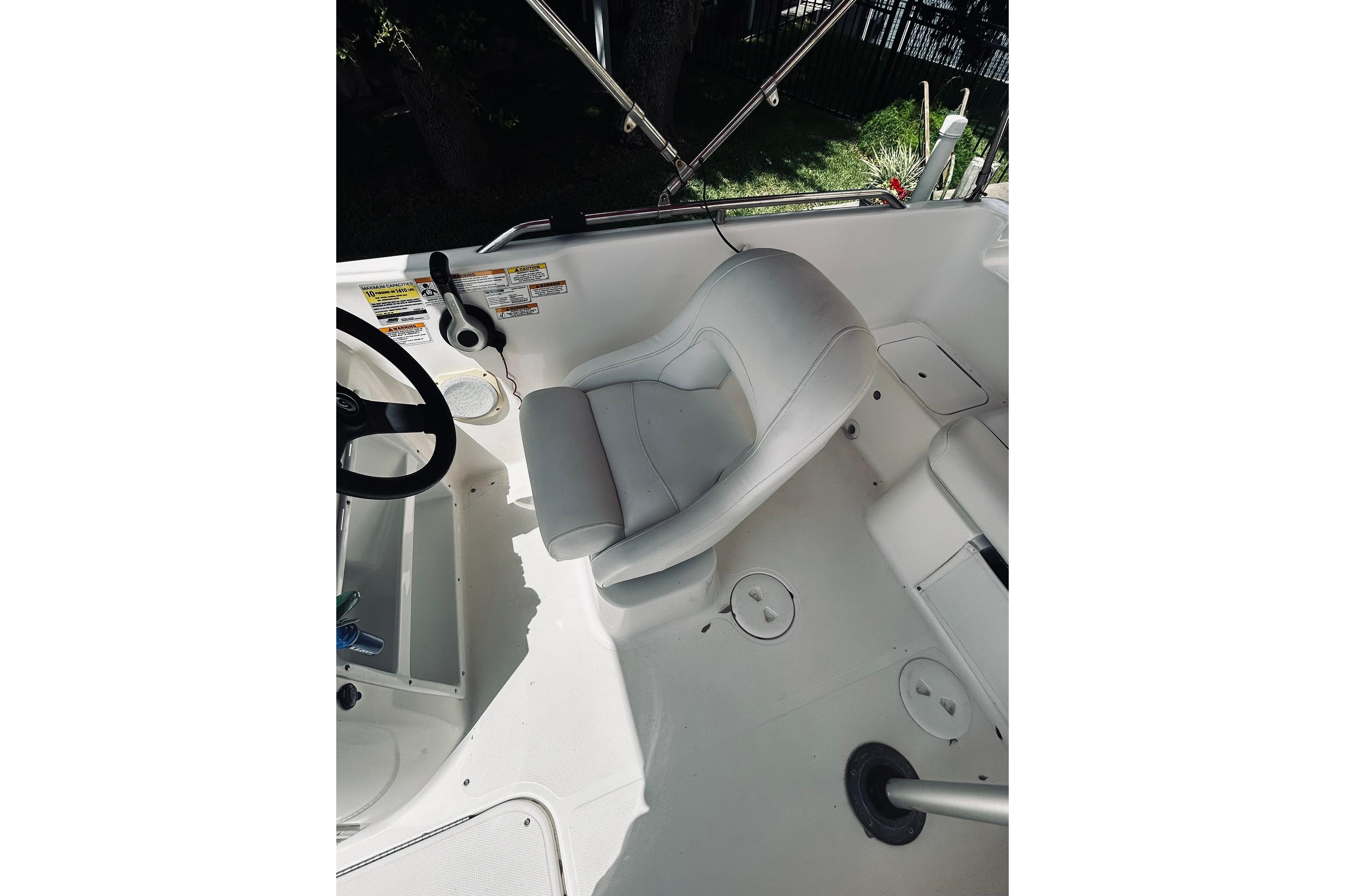 2013 Hurricane SunDeck Sport 201 OB boat interior with steering wheel and seating area.