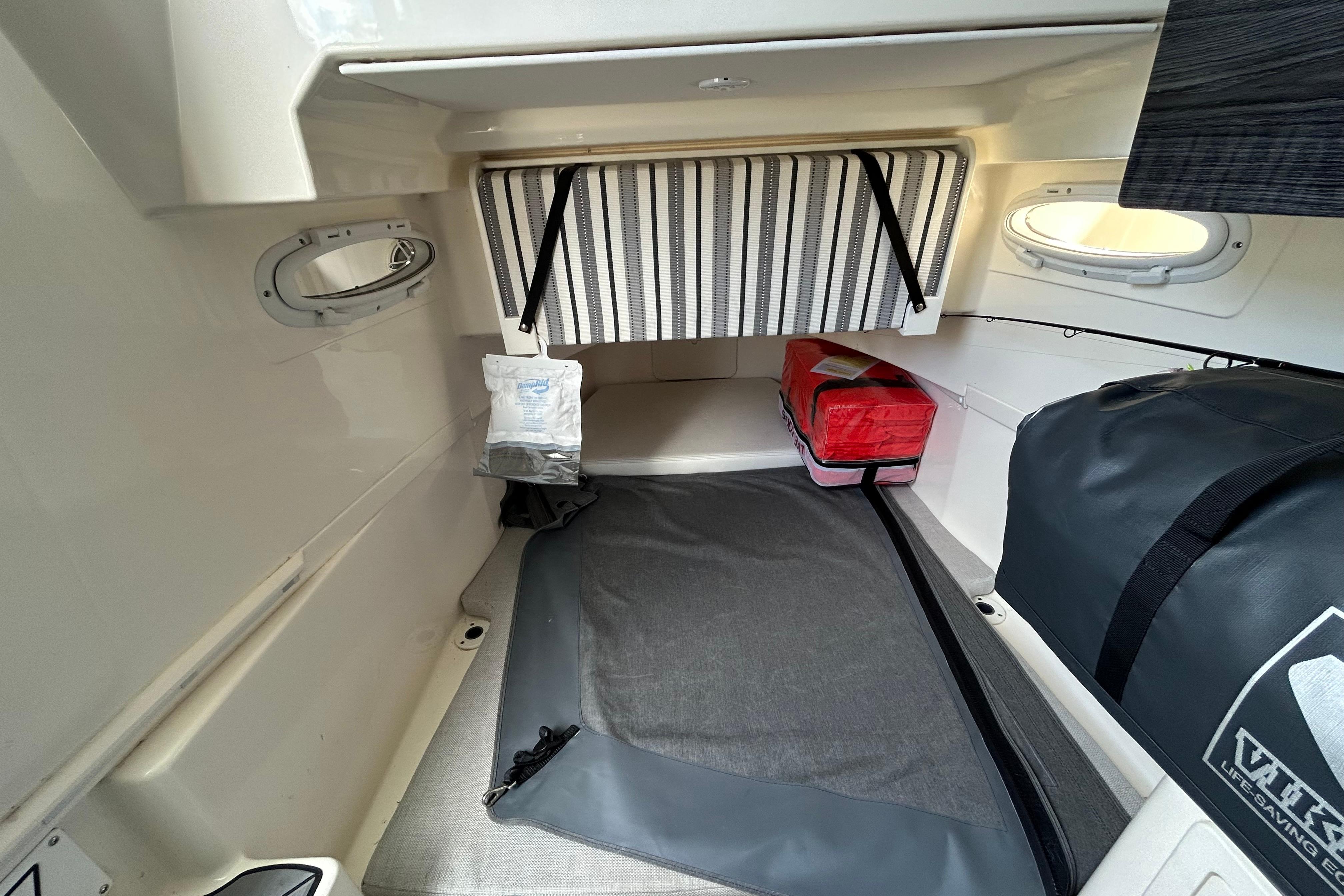 2020 Cobia 350 Center Console cabin interior with storage bags and portholes.
