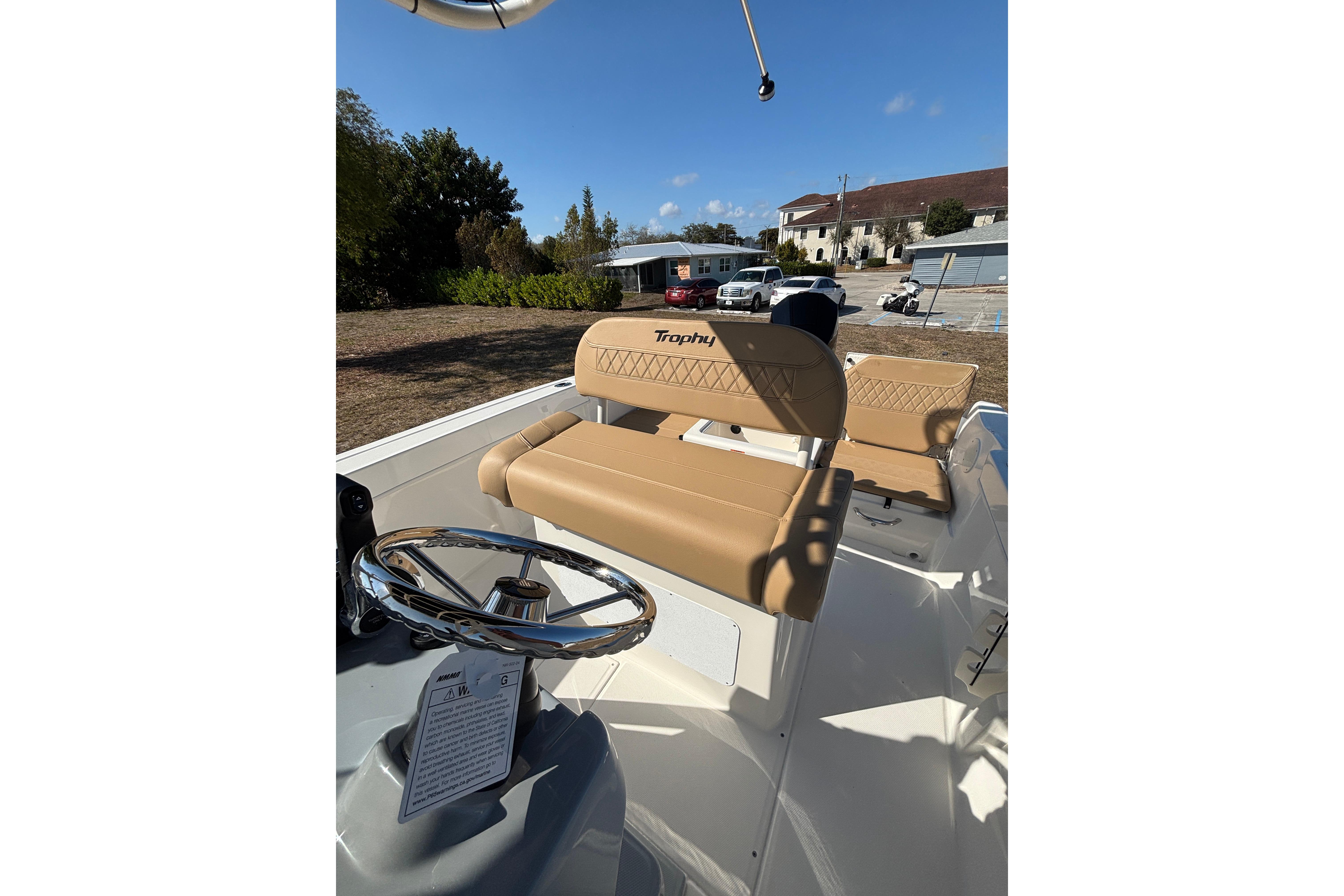 2026 Bayliner Trophy T22CC boat interior with tan seating and steering wheel.