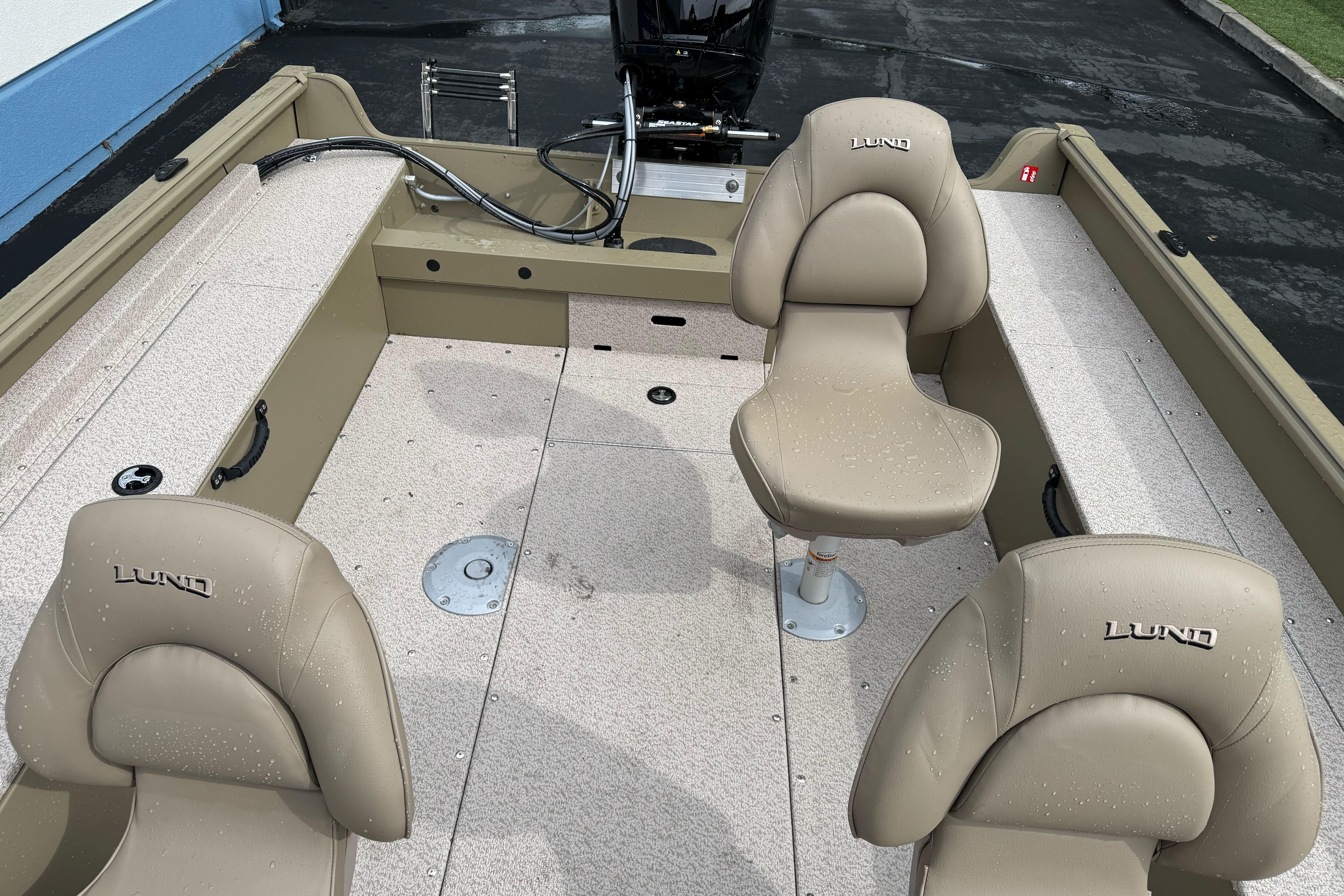 2026 Lund 2075 Alaskan SS boat interior with beige seats and spacious layout.