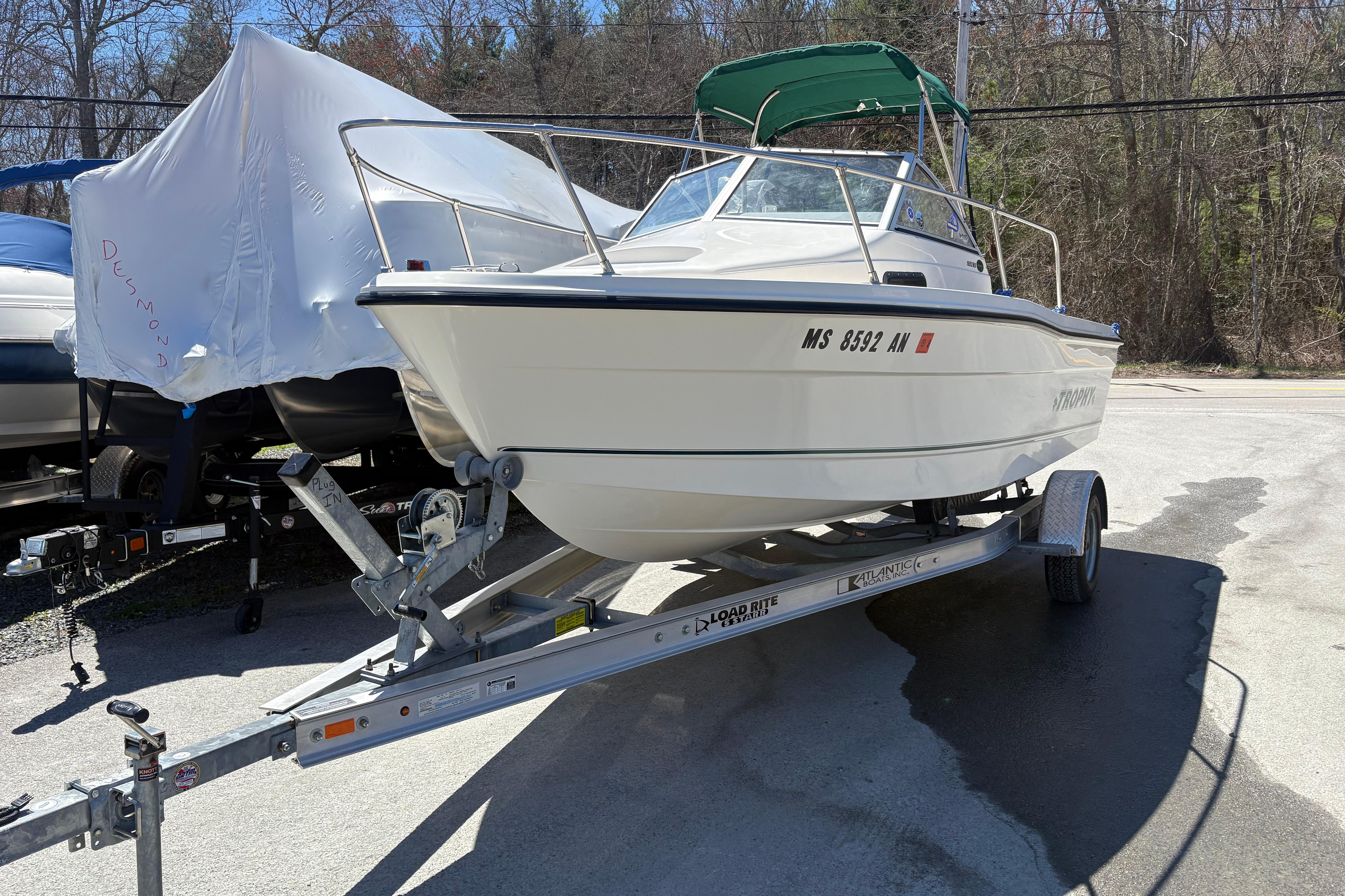 2004 Trophy 1802 Walkaround boat on trailer, parked outdoors.