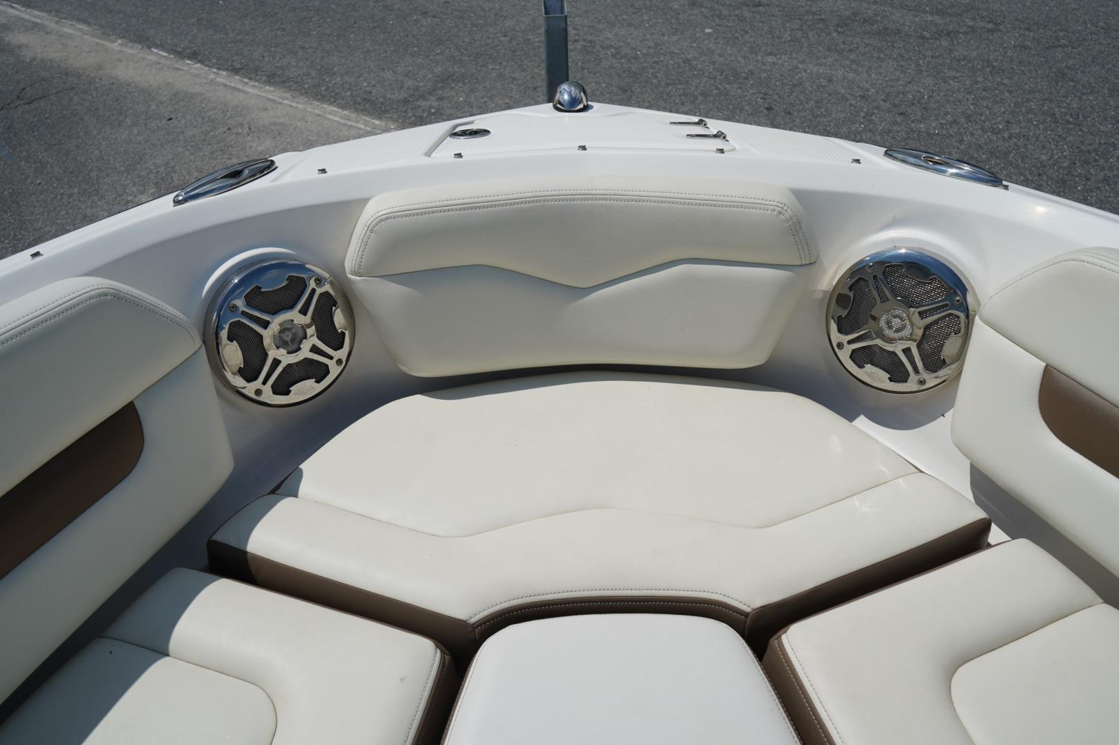 2013 Chaparral 206 SSi boat interior with white cushioned seating and built-in speakers.