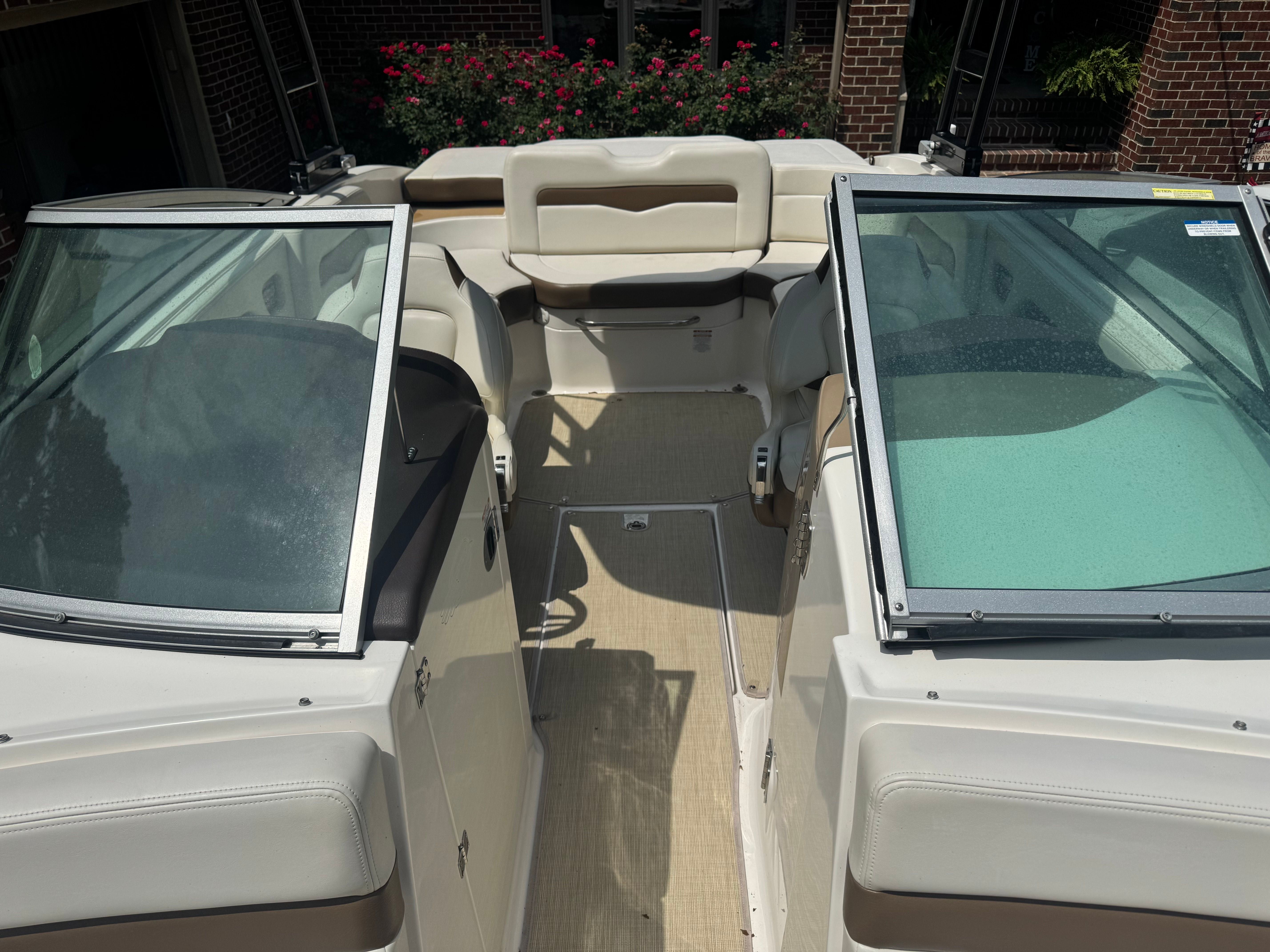Interior of a 2016 Chaparral 246 SSi boat with open windshield.