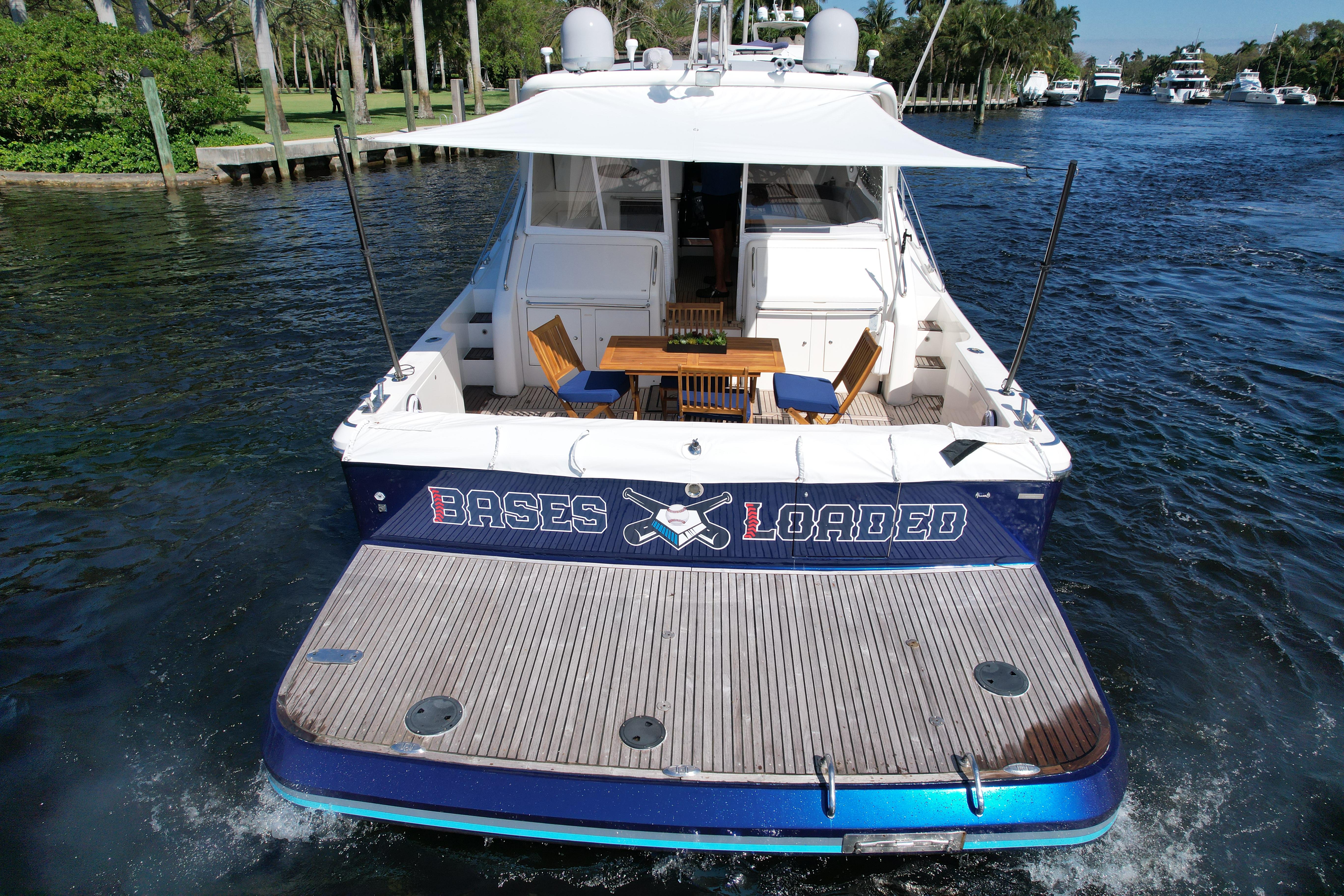 1999 Uniesse 57 Open yacht on water, rear view with deck and seating area.