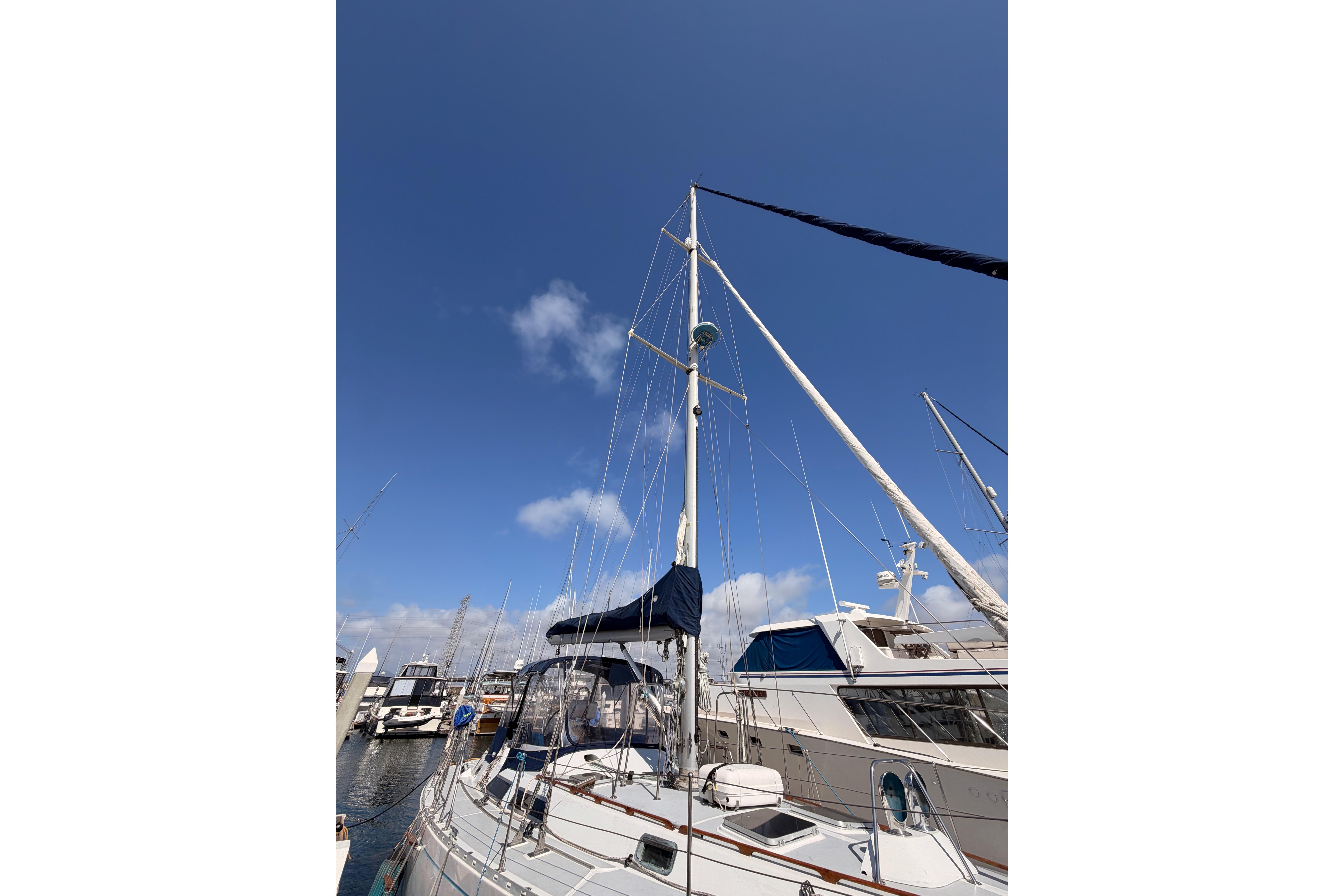 Sailboat Hylas 51 from 1991 docked under a clear blue sky.