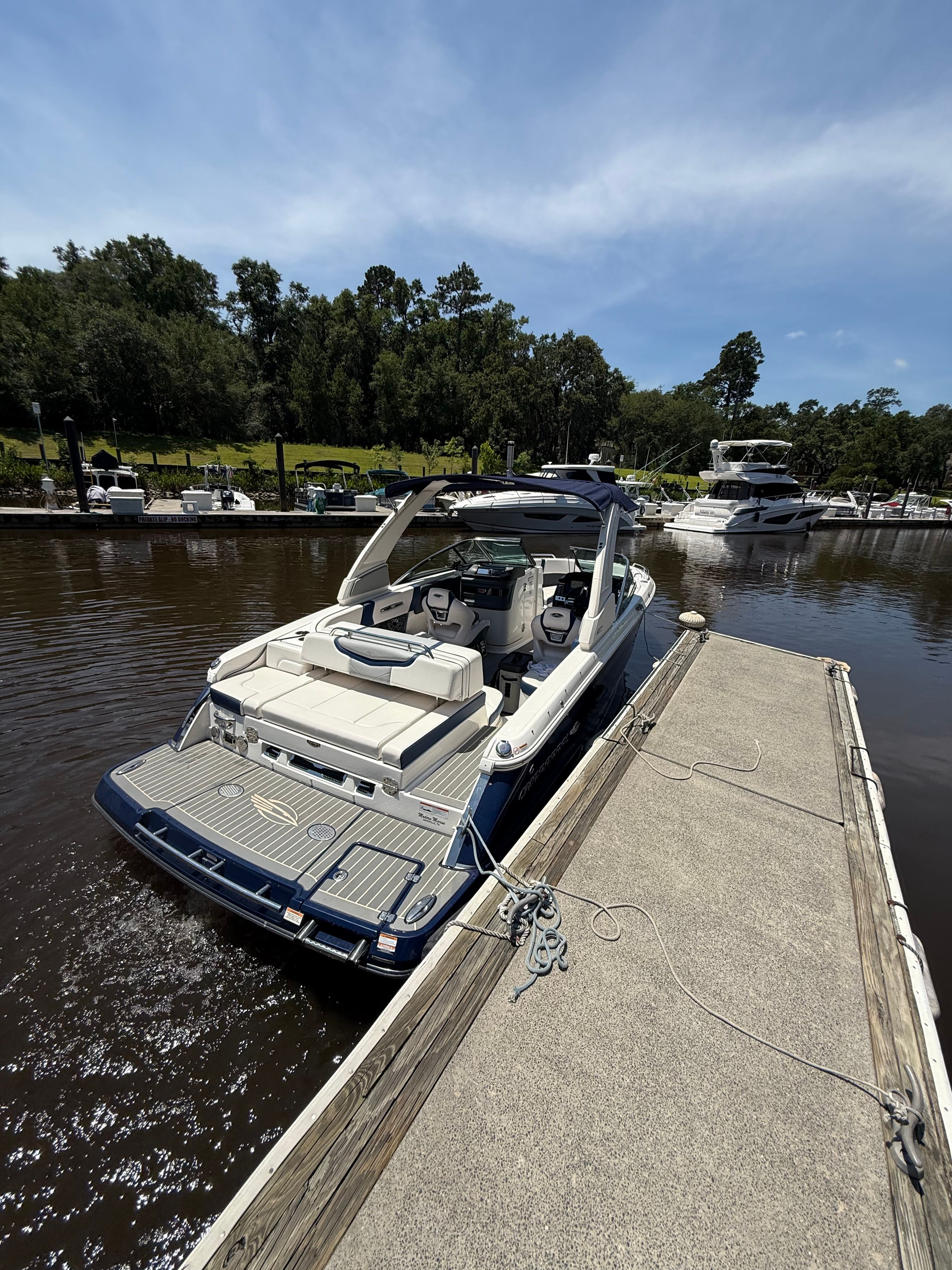2020 Chaparral 256 SSX boat docked on a sunny day.