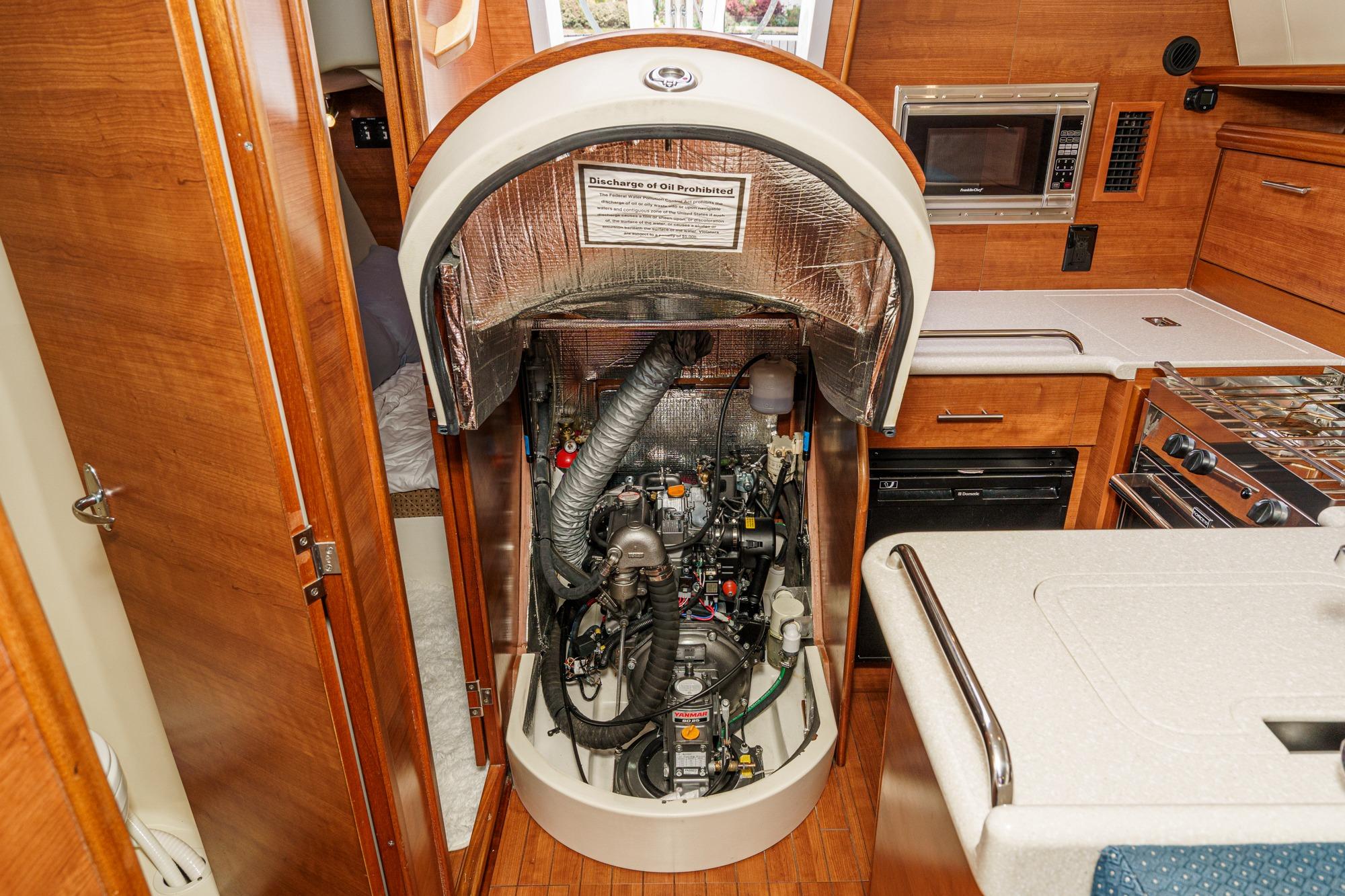 Engine compartment of a 2015 Hunter 33 sailboat, showcasing interior design and equipment.