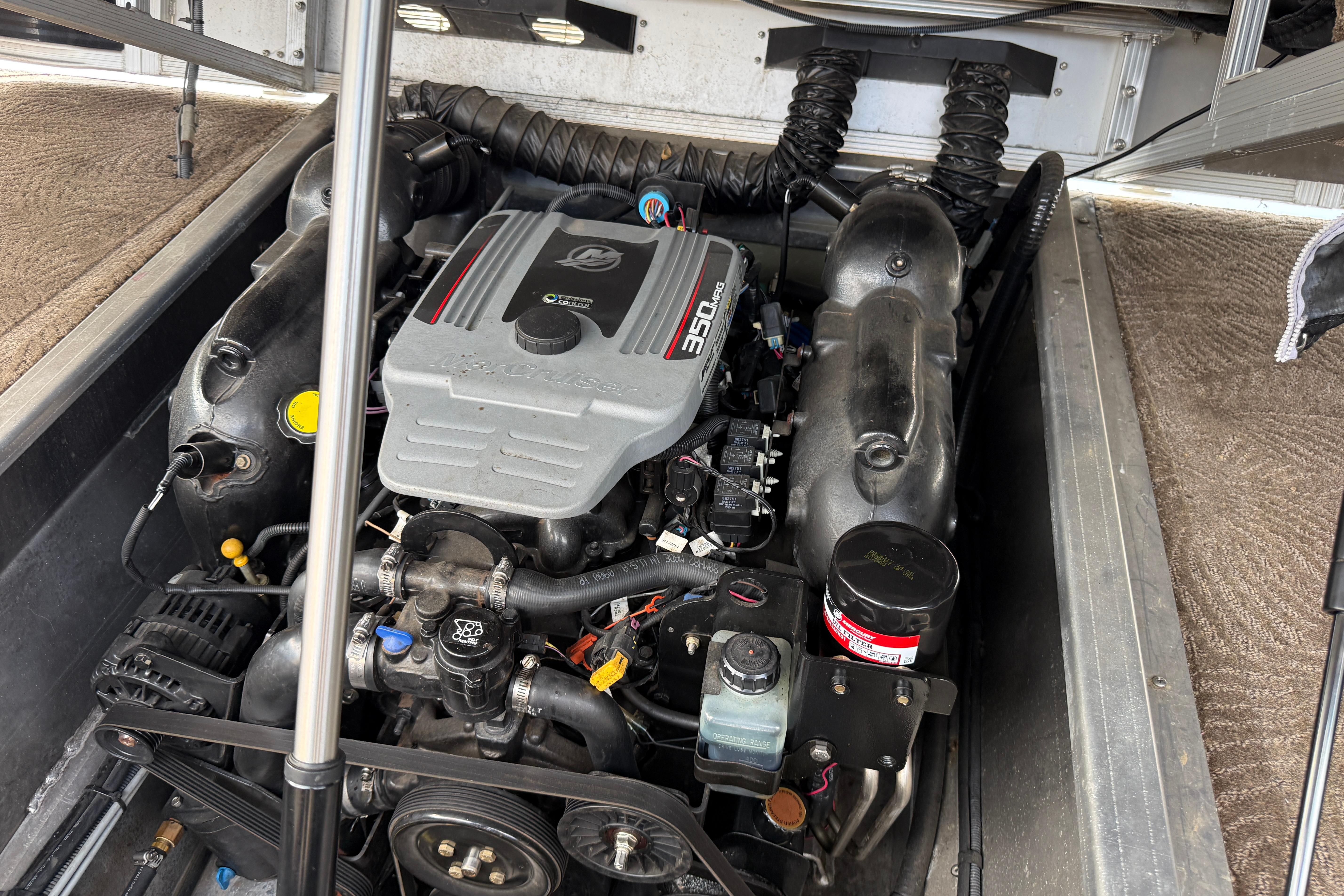 Engine compartment of a 2011 Bennington 2575QCW I/O boat, featuring a 350 engine.