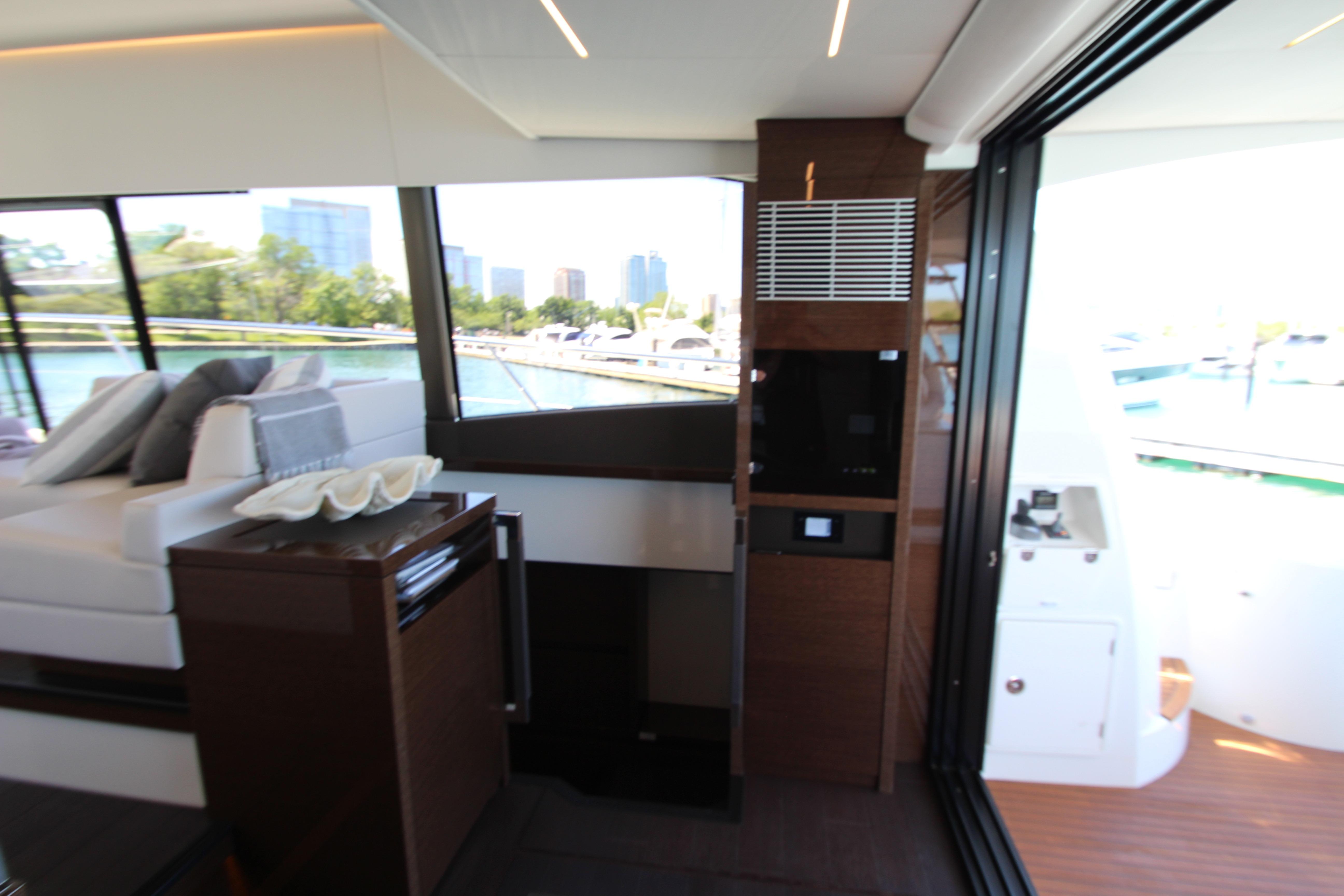Luxurious interior of 2022 Prestige 520 yacht with modern design and scenic marina view.
