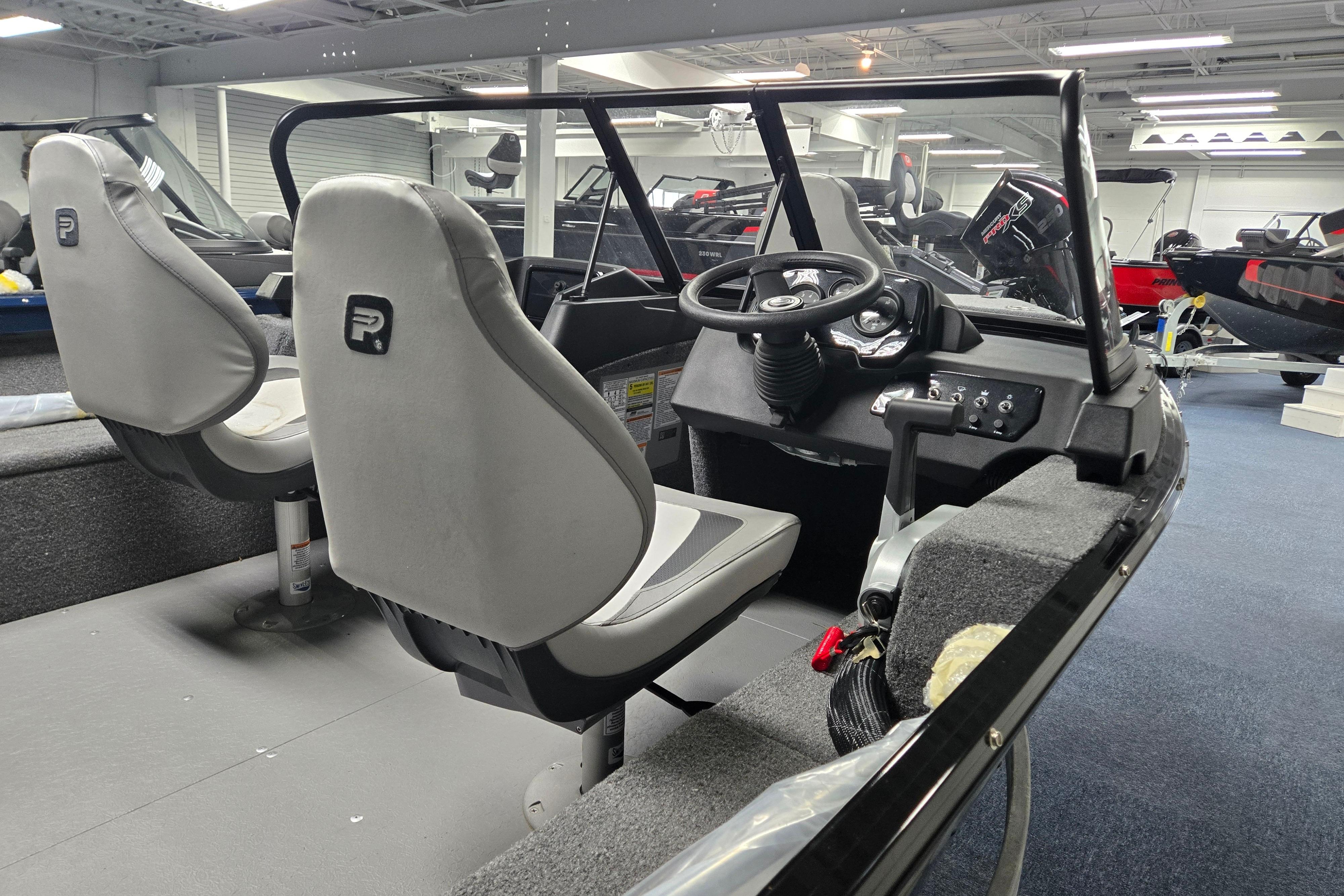 Interior of 2026 Princecraft Holiday 162 WS MAX boat, featuring steering console and seating.
